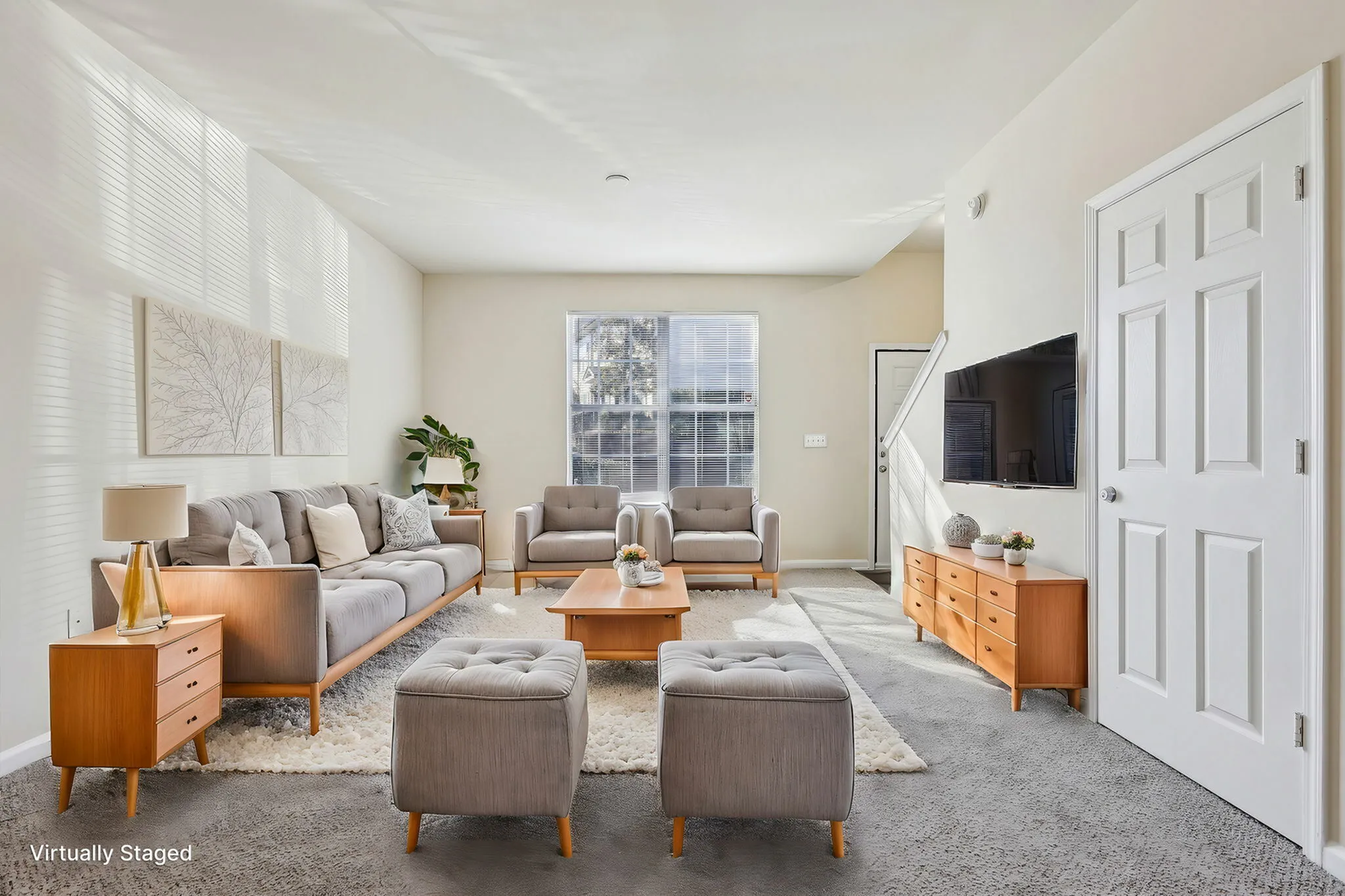 Virtually staged living room with modern gray furniture and large windows.
