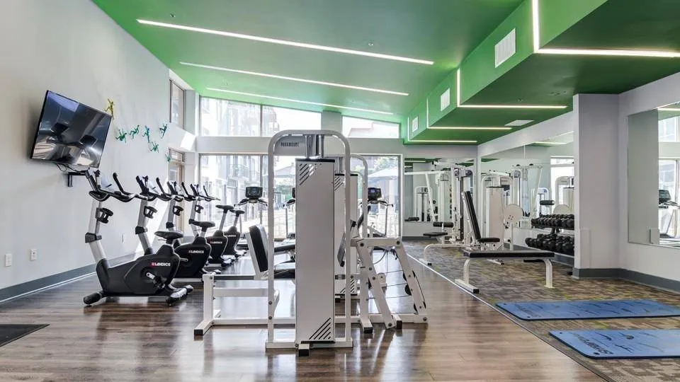 picture of fitness center including cycling, free weights and machines in picture