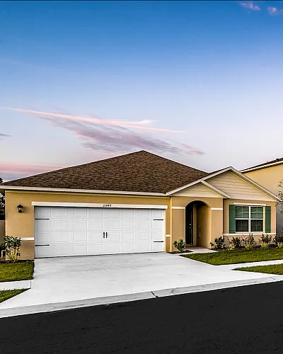 Charming suburban street with modern townhouses under a vibrant sunset, offering a serene neighborhood vibe.