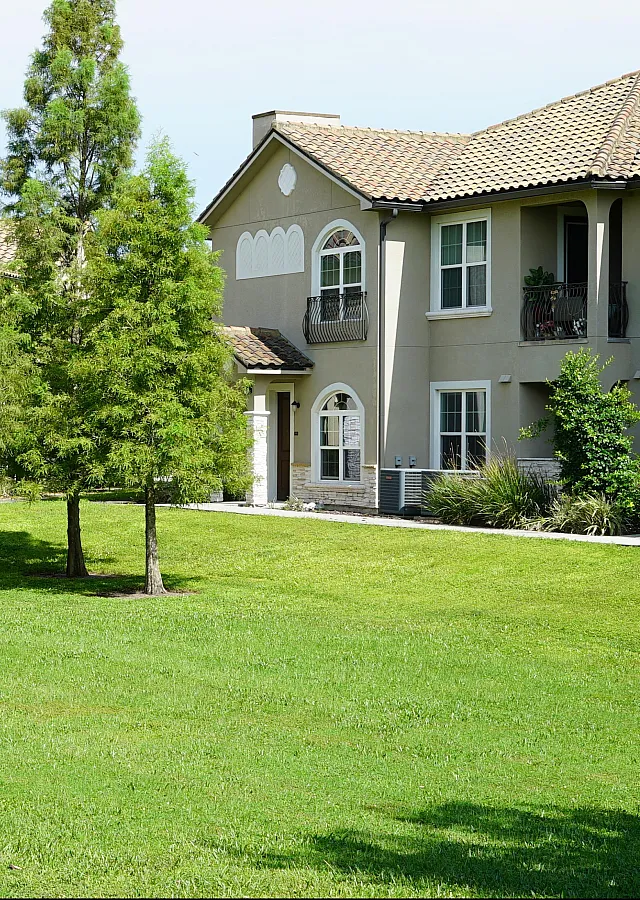 Charming suburban apartment complex with elegant architecture and lush landscaping, offering serene living in a vibrant community.