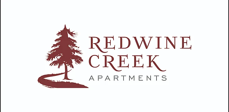 Elegant logo for Redwine Creek Apartments featuring a stylized red pine tree and flowing creek, symbolizing natural beauty and serene living.