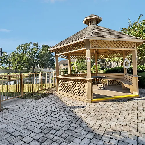 Charming wooden gazebo in a serene outdoor setting, perfect for relaxation and enjoying picturesque views.