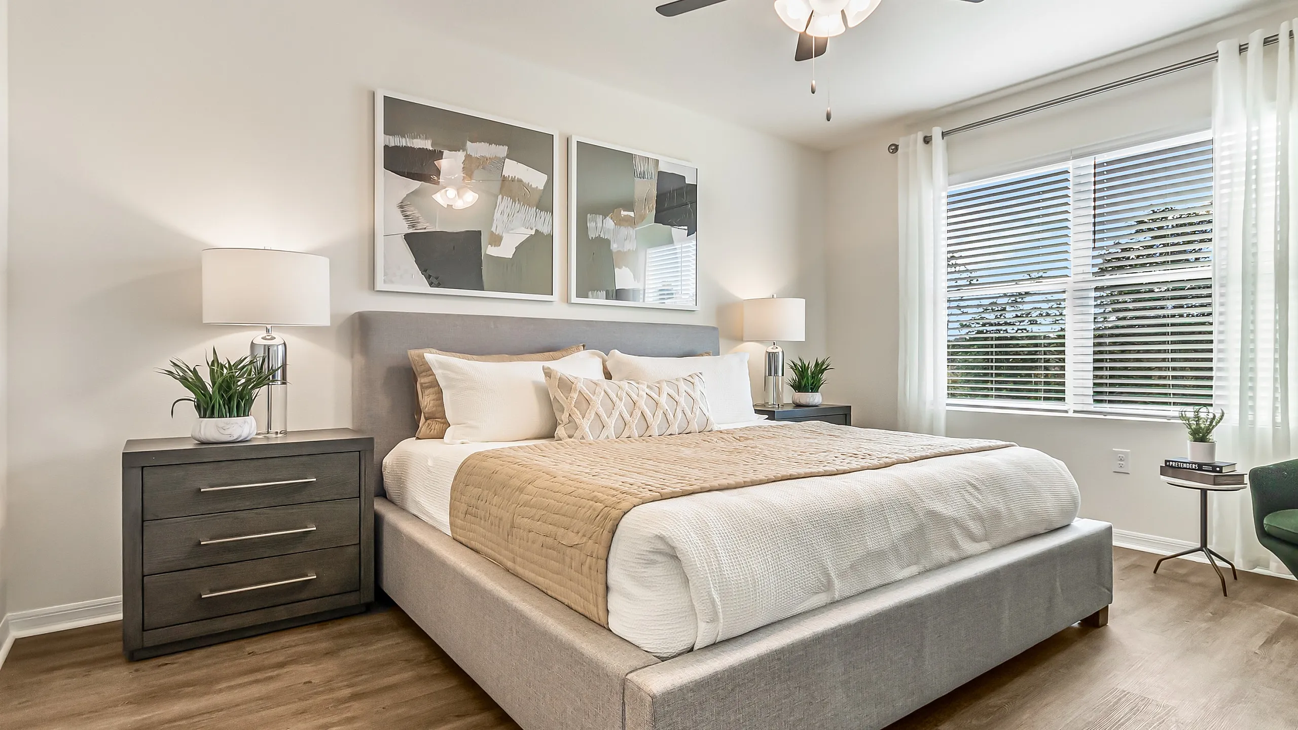Inviting bedroom with a plush king-size bed, elegant decor, and natural light streaming through large windows.
