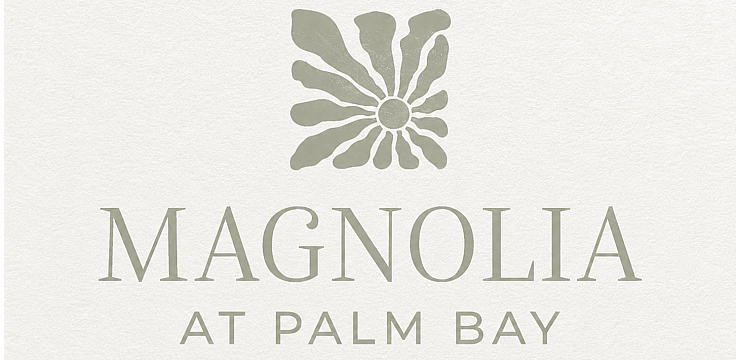 Elegant Magnolia At Palm Bay logo featuring a stylized floral design in soft green tones.