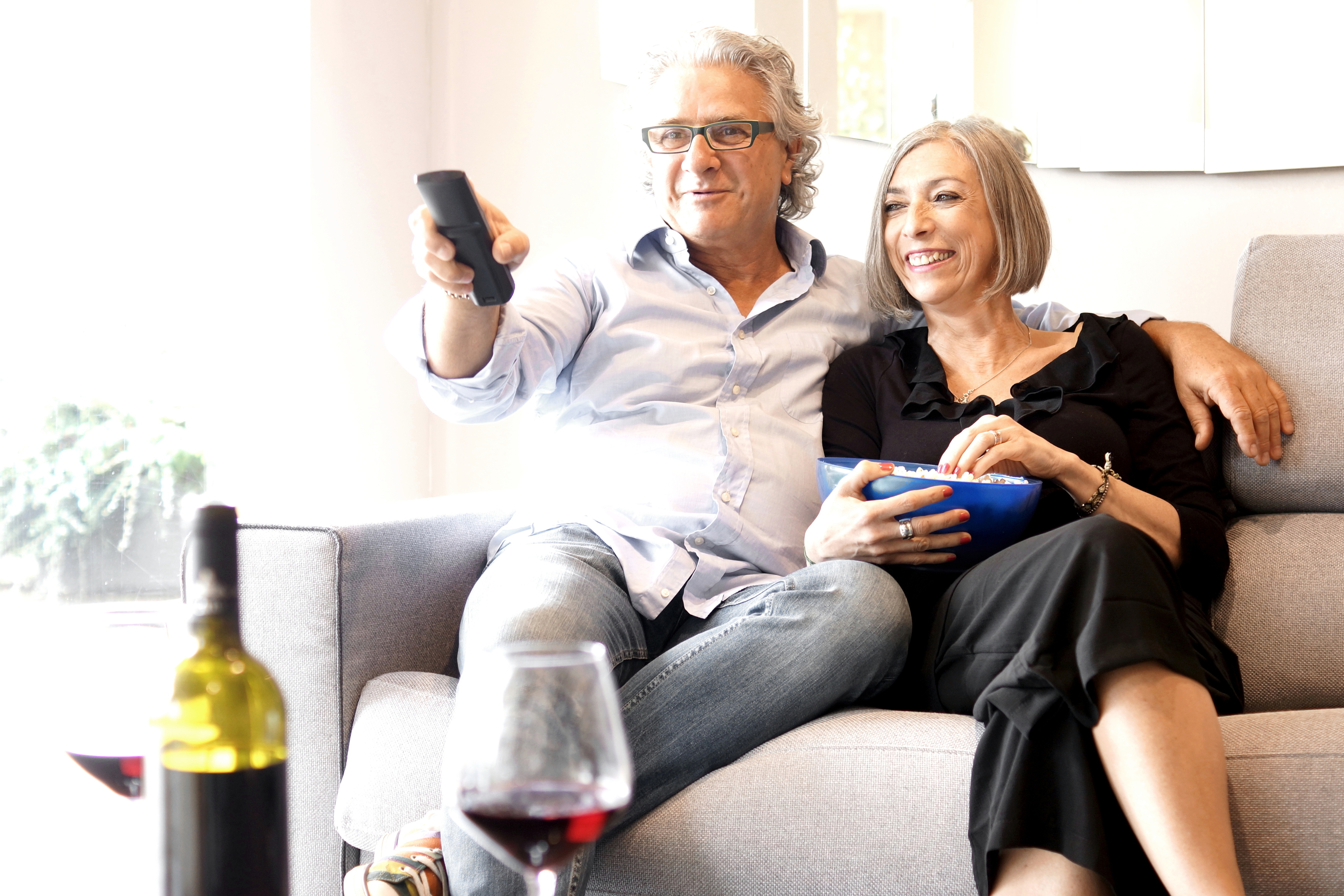 older adults watching tv at home 