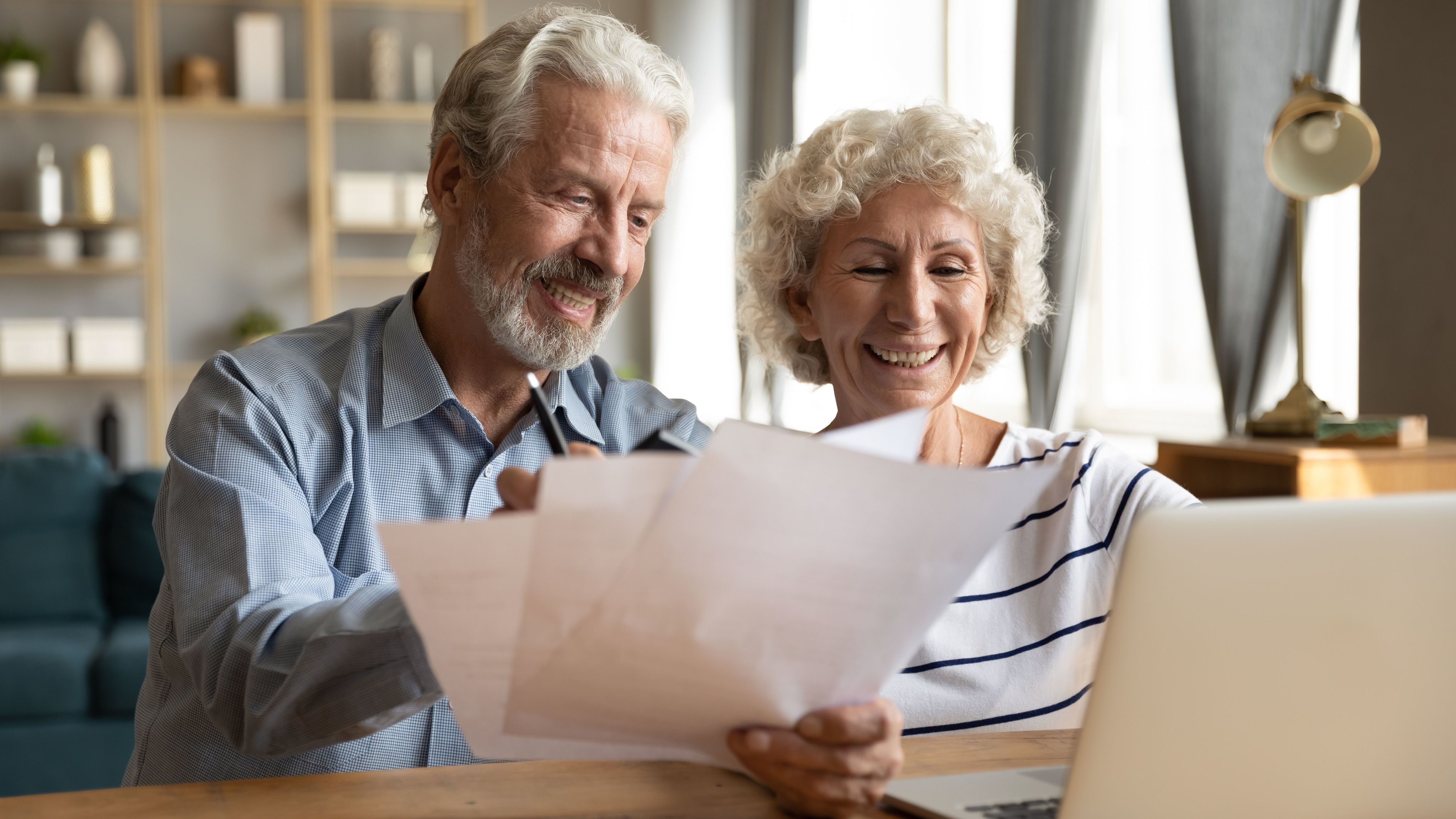 Senior couple reviewing papers at a table