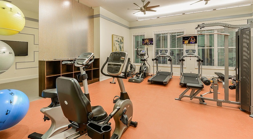 Monterey Pointe, interior, fitness center, bikes, treadmills, elliptical, weight machines, ceiling fans, large windows