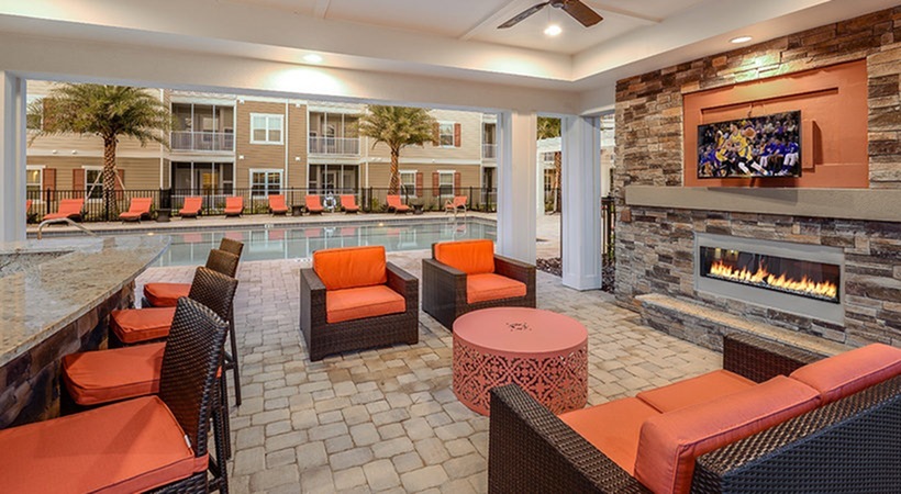 Monterey Pointe, exterior, pavilion seating, tv, fire place,  ceiling fans, bar seating, adjacent to pool, orange lounge chairs, balconies, orange and black wicker couch set, arm chairs