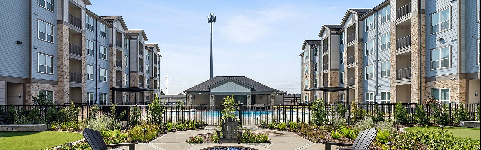 Firepit with seating and buildings on each side of pit