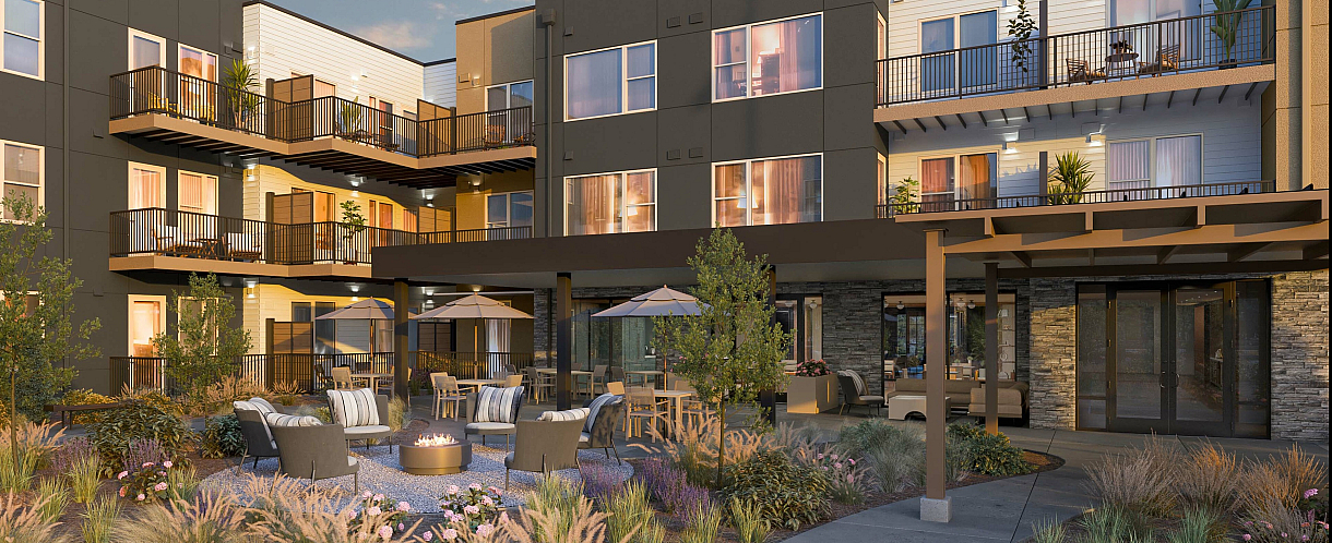 Modern apartment complex with elegant balconies, a beautifully landscaped courtyard, and cozy outdoor seating around a fire pit, perfect for social gatherings.
