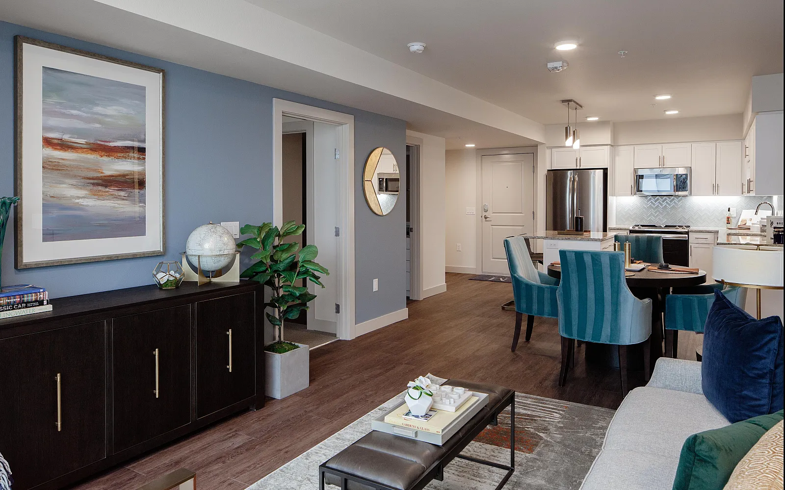 Contemporary open-concept living area with chic furniture, elegant dining space, and a modern kitchen. Vibrant decor with a sophisticated touch.