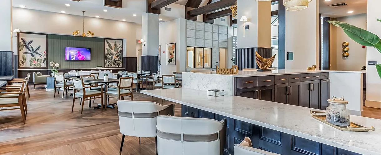 Elegant dining area with modern decor, featuring wooden beams, stylish lighting, and a spacious countertop in a luxurious setting.