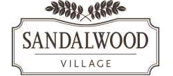 Elegant Sandalwood Village logo featuring decorative leaf accents.