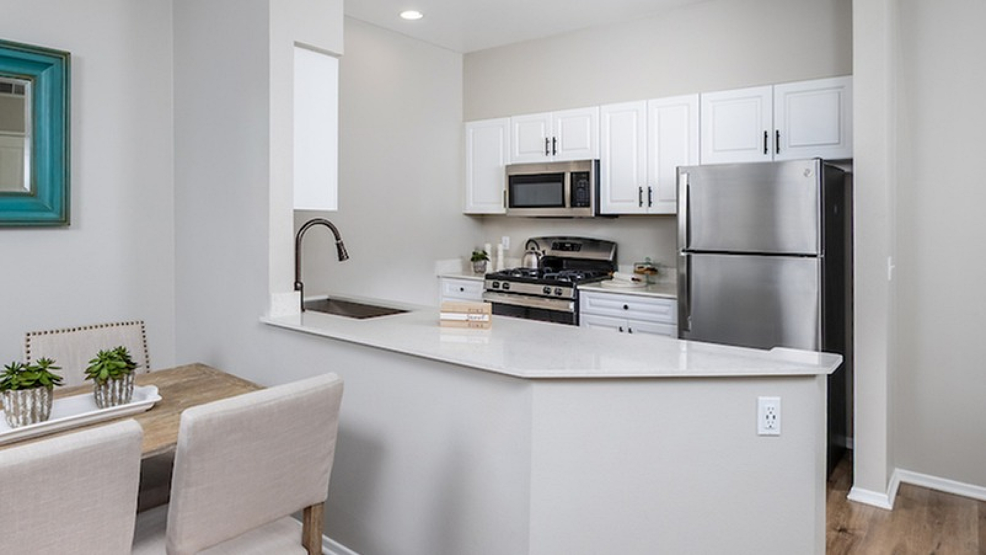 Model apartment with an open floor plan at Elate Rancho Cucamonga in Rancho Cucamonga, CA, featuring a view of the kitchen.