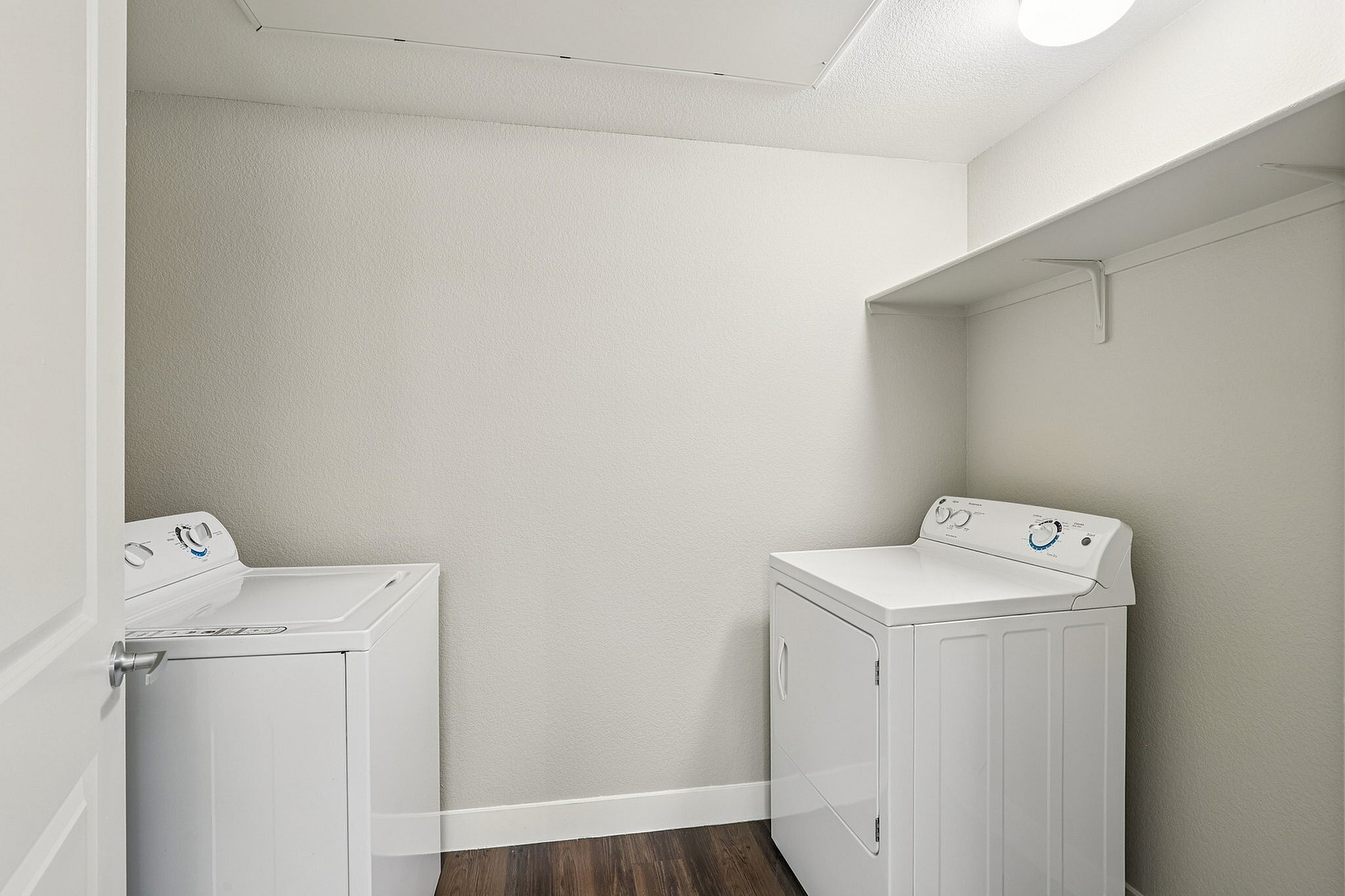 Bright laundry room featuring modern washer and dryer set against a sleek minimalist design.