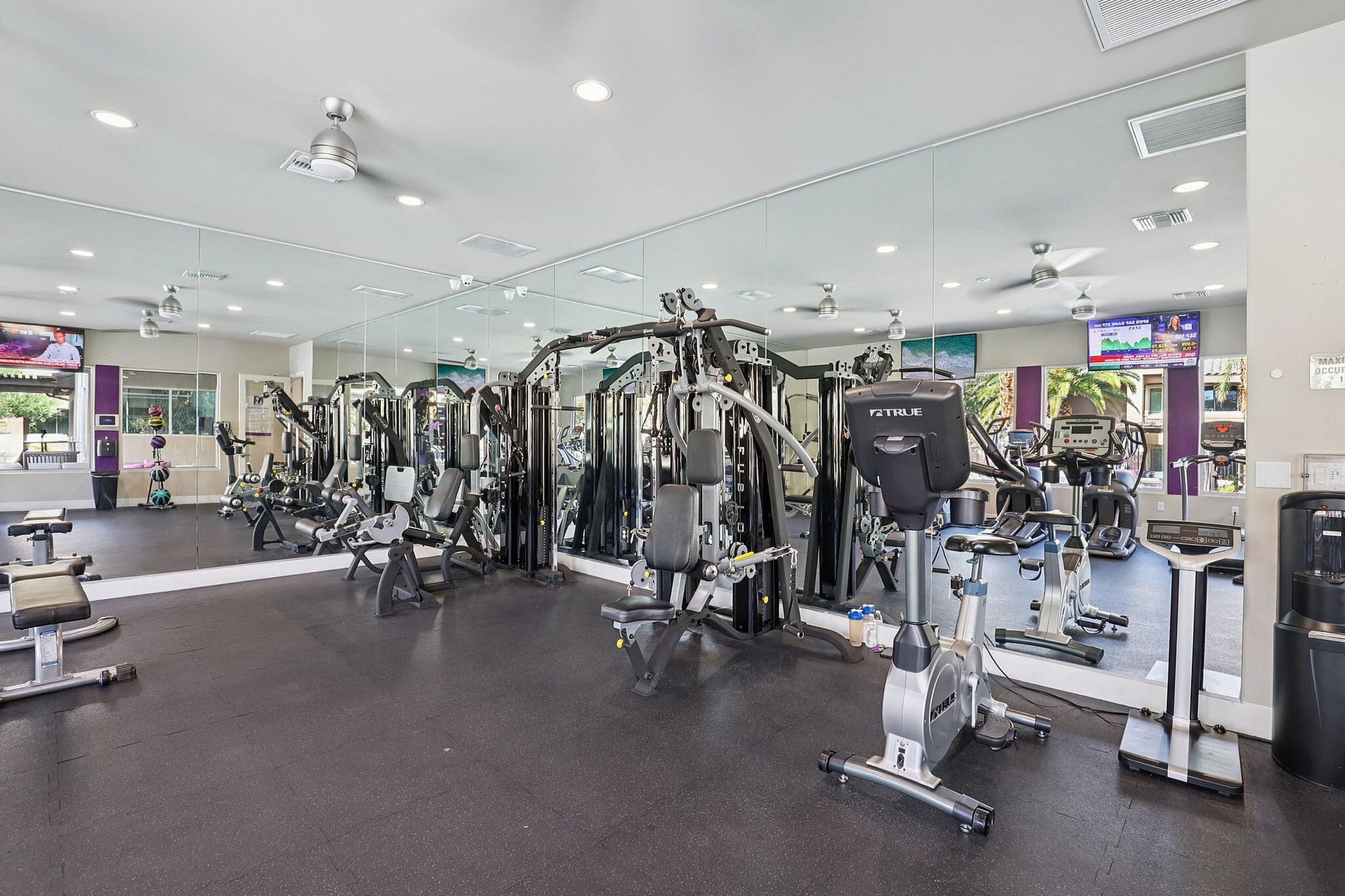 Modern fitness center with state-of-the-art equipment, mirrored walls, and bright, inviting design.