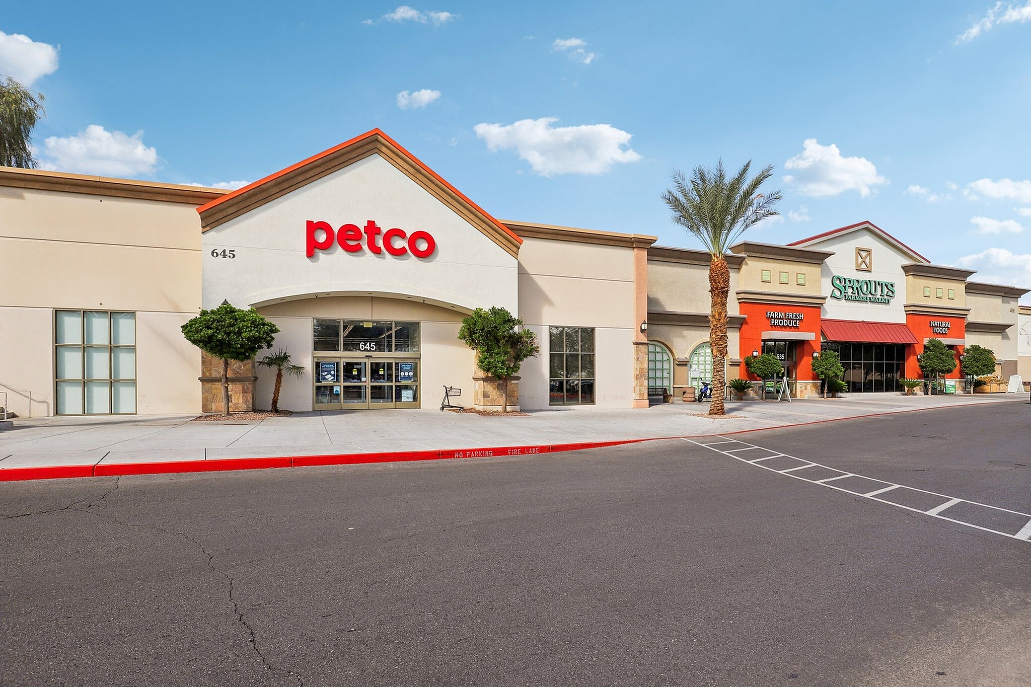 Modern shopping plaza featuring Petco and Sprouts, showcasing convenient pet supplies and fresh natural foods.
