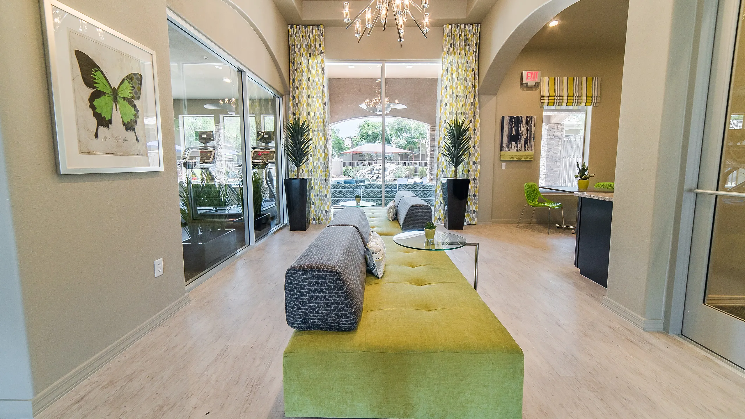 Chic and inviting lounge area featuring modern decor, a vibrant green sofa, and elegant lighting, creating a warm and stylish ambiance.