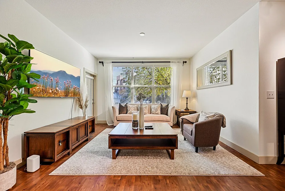 Chic and inviting living room with natural light, cozy seating, and elegant decor, ideal for relaxation and gatherings.