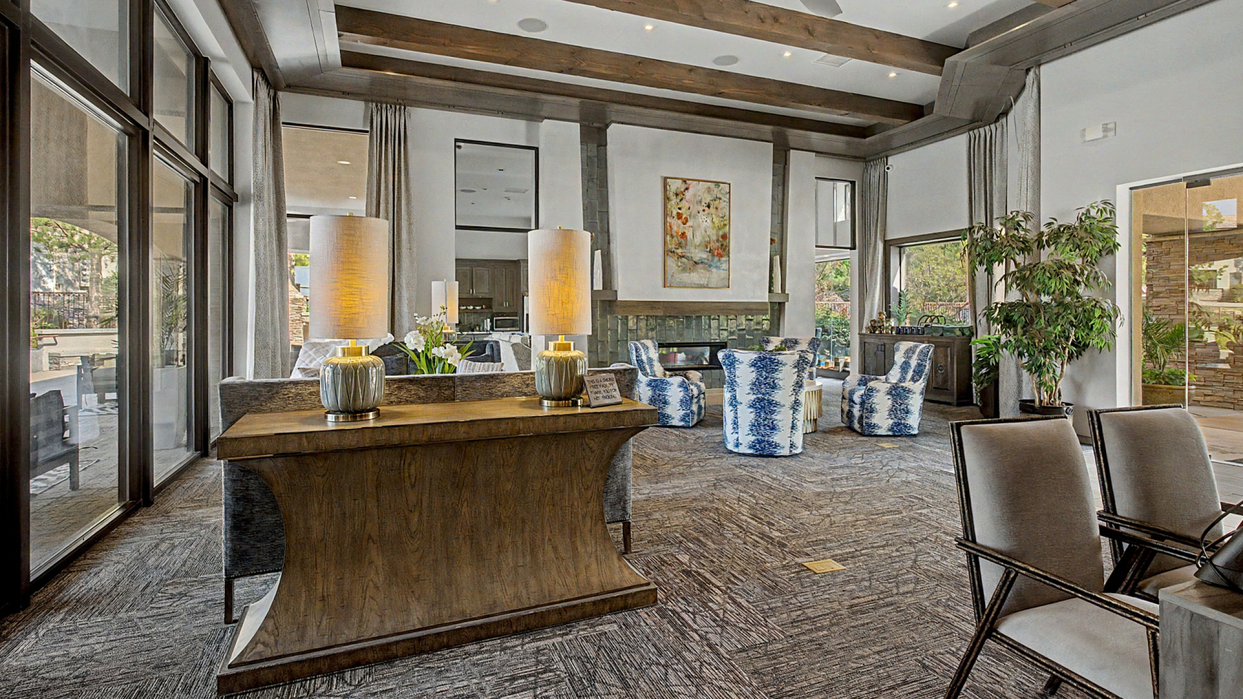 Elegant living room with high ceilings, cozy seating, and warm lighting creating a luxurious and inviting atmosphere.
