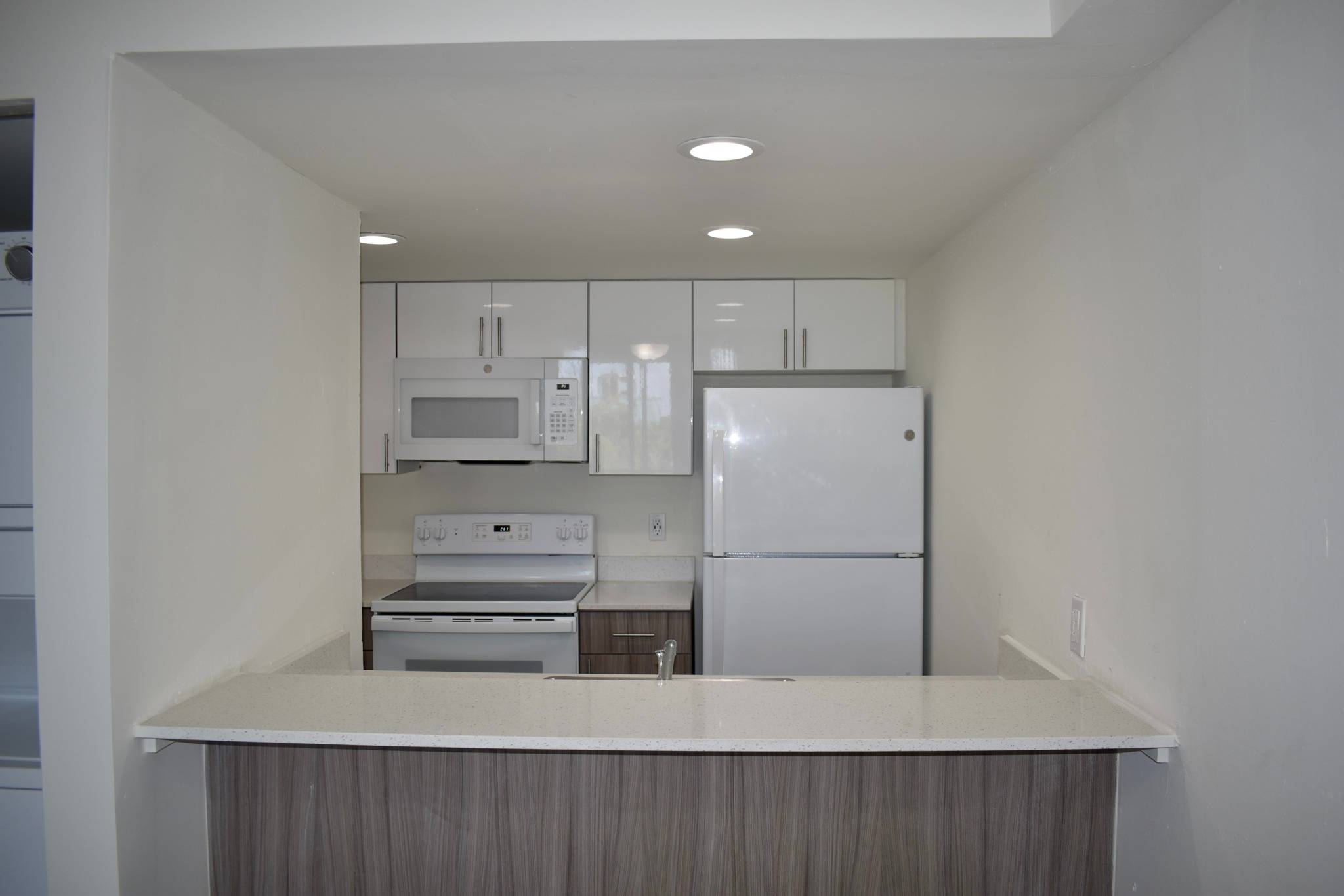 Granite Countertops with Modern, White Plywood Cabinetry With Self-Closing Hinges*