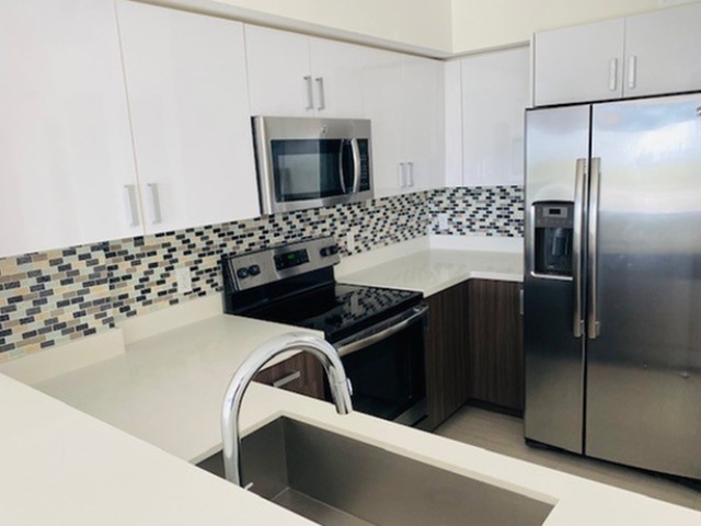 Quartz Countertops with Modern, White European-Style Cabinetry With Self-Closing Hinges & Designer Backsplash Tile*