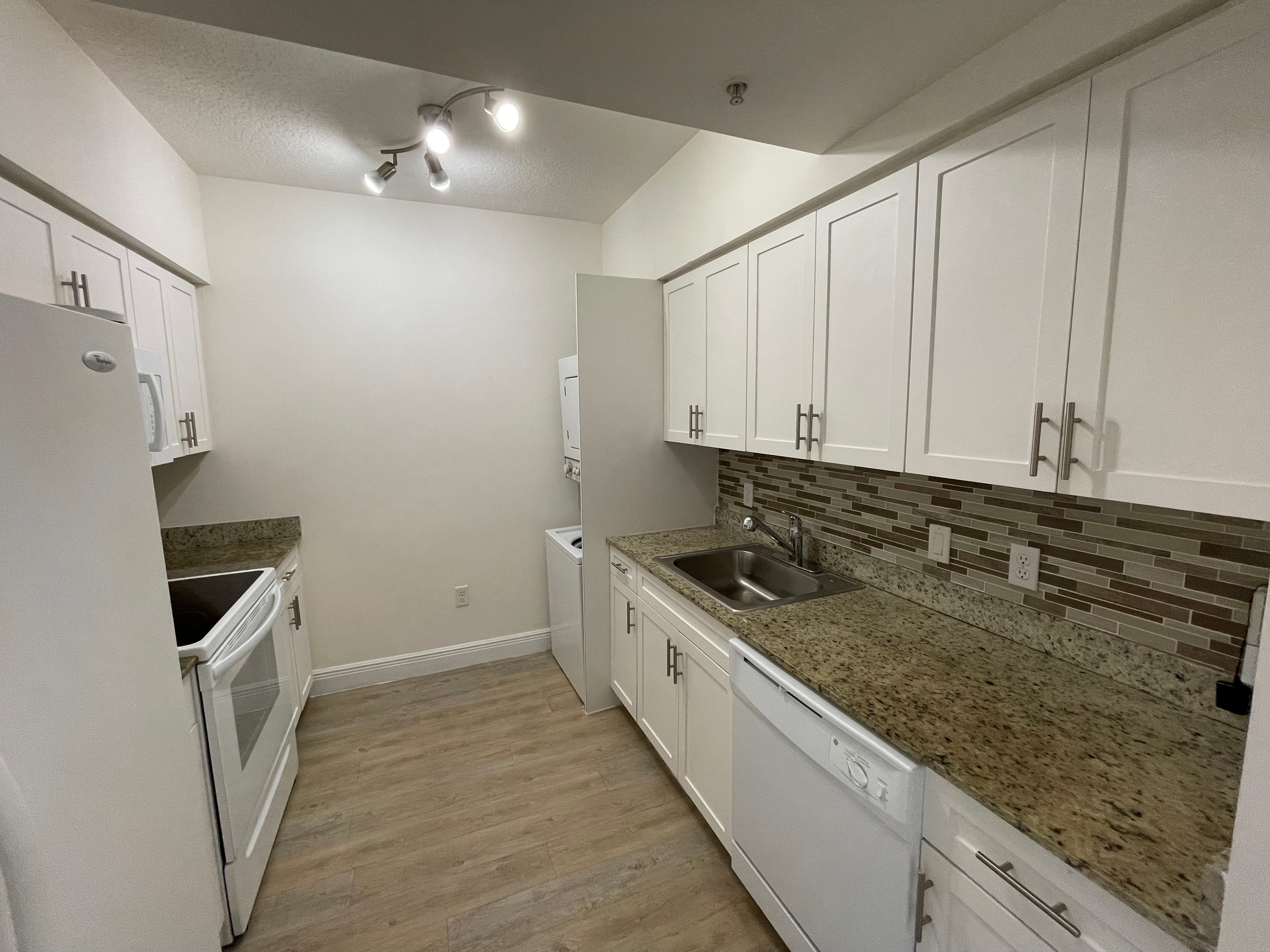 Granite Countertops with Modern, White Plywood Cabinetry With Self-Closing Hinges & Designer Glass Backsplash Tile*