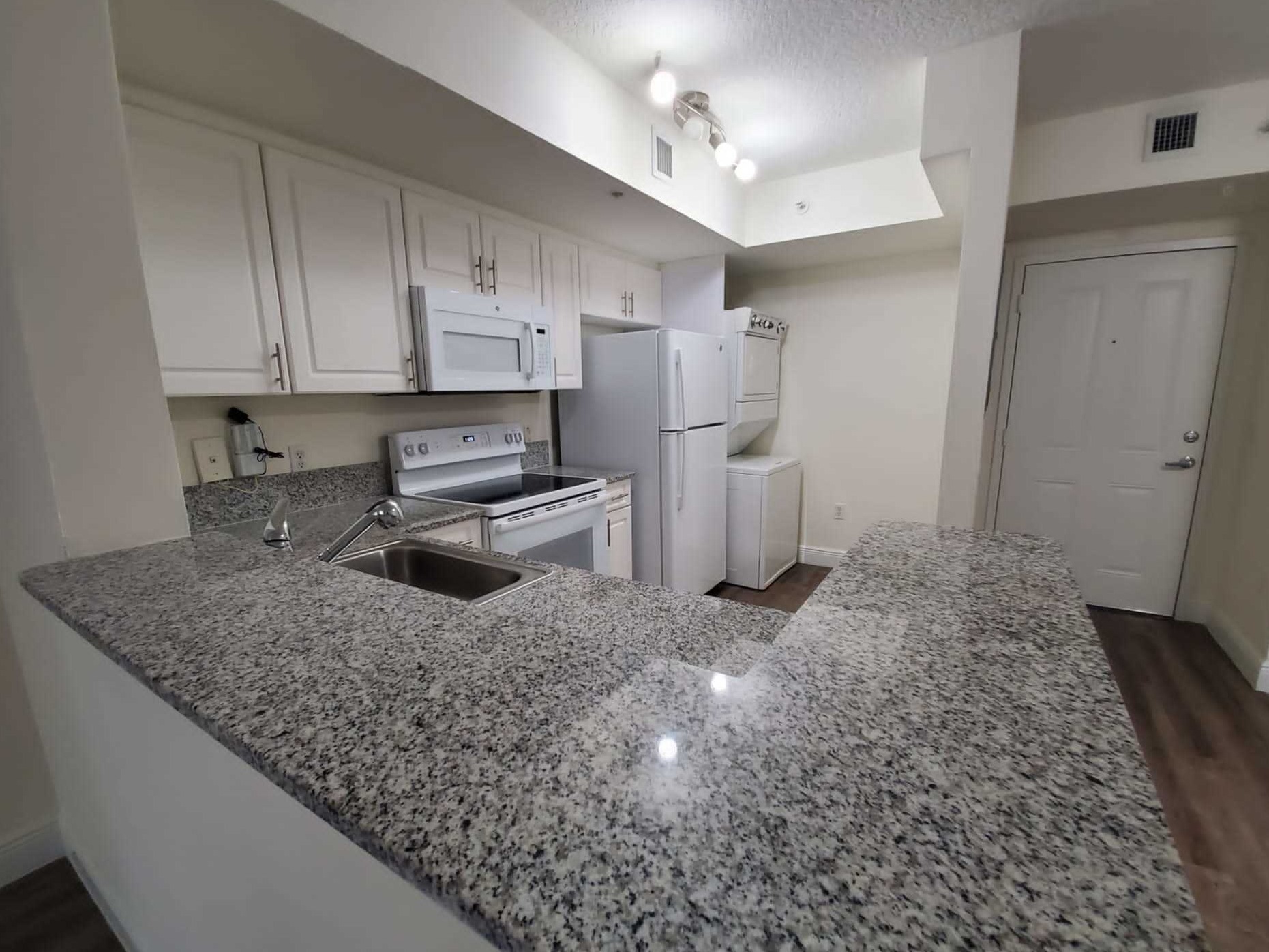 Granite/Quartz Countertops with Modern, White European-Style Cabinetry With Self-Closing Hinges