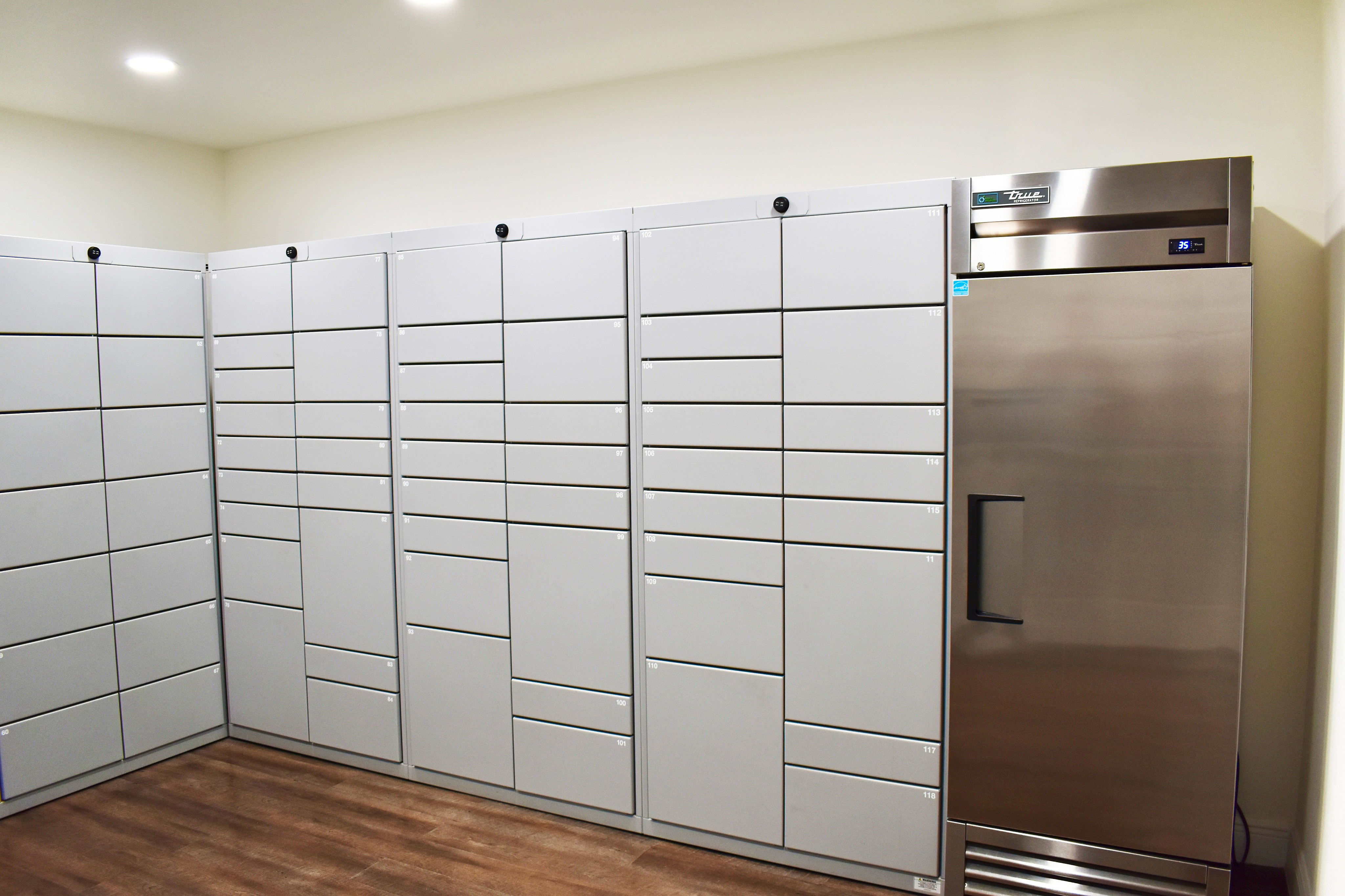 Modern package locker room with sleek metallic storage units for secure parcel delivery.