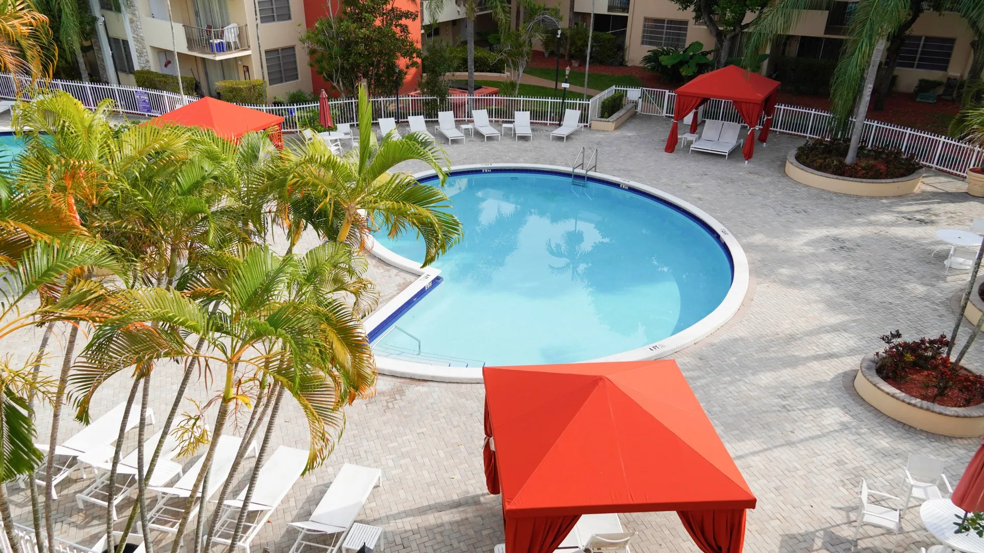 Aerial pool view with cabanas