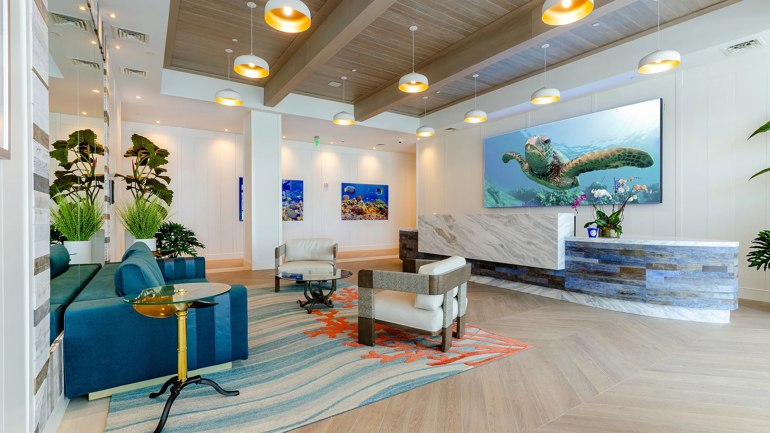 Luxurious lobby with modern seating, vibrant artwork, and a stunning wooden ceiling, creating a welcoming ambiance.