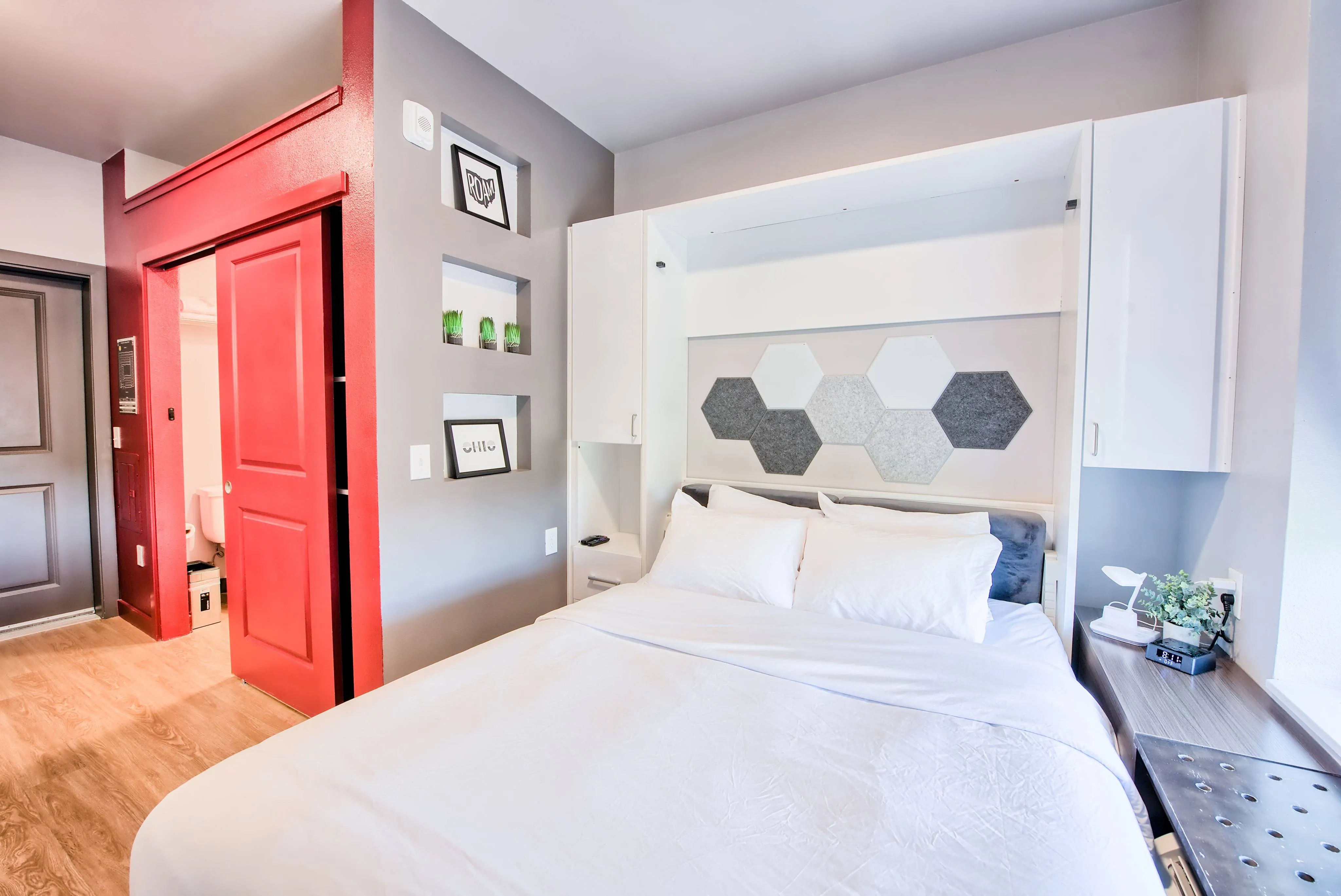 queen sized bed in a modern style micro unit apartment