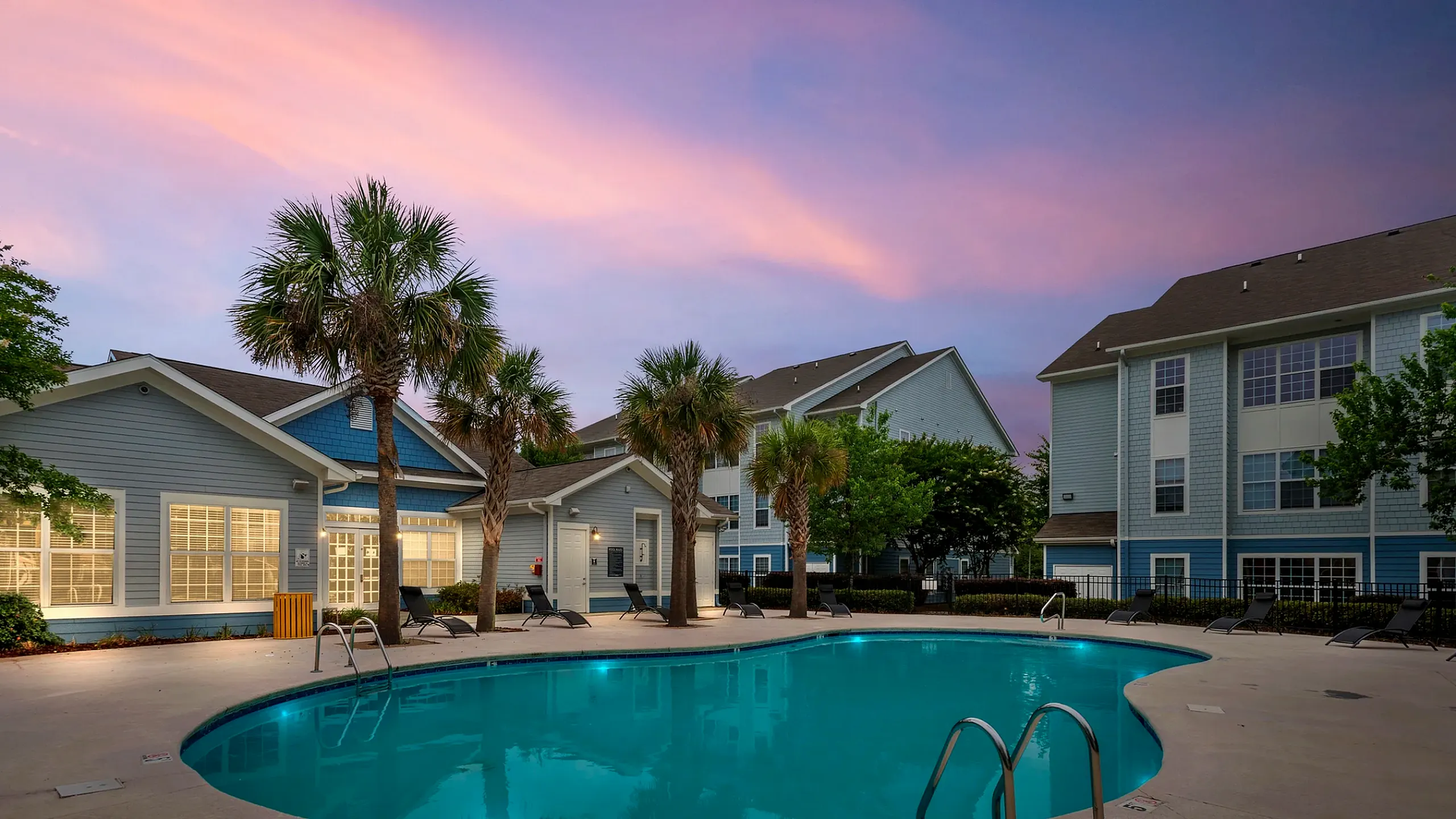 the view at pembroke student apartments pool and buildings with sunset sky