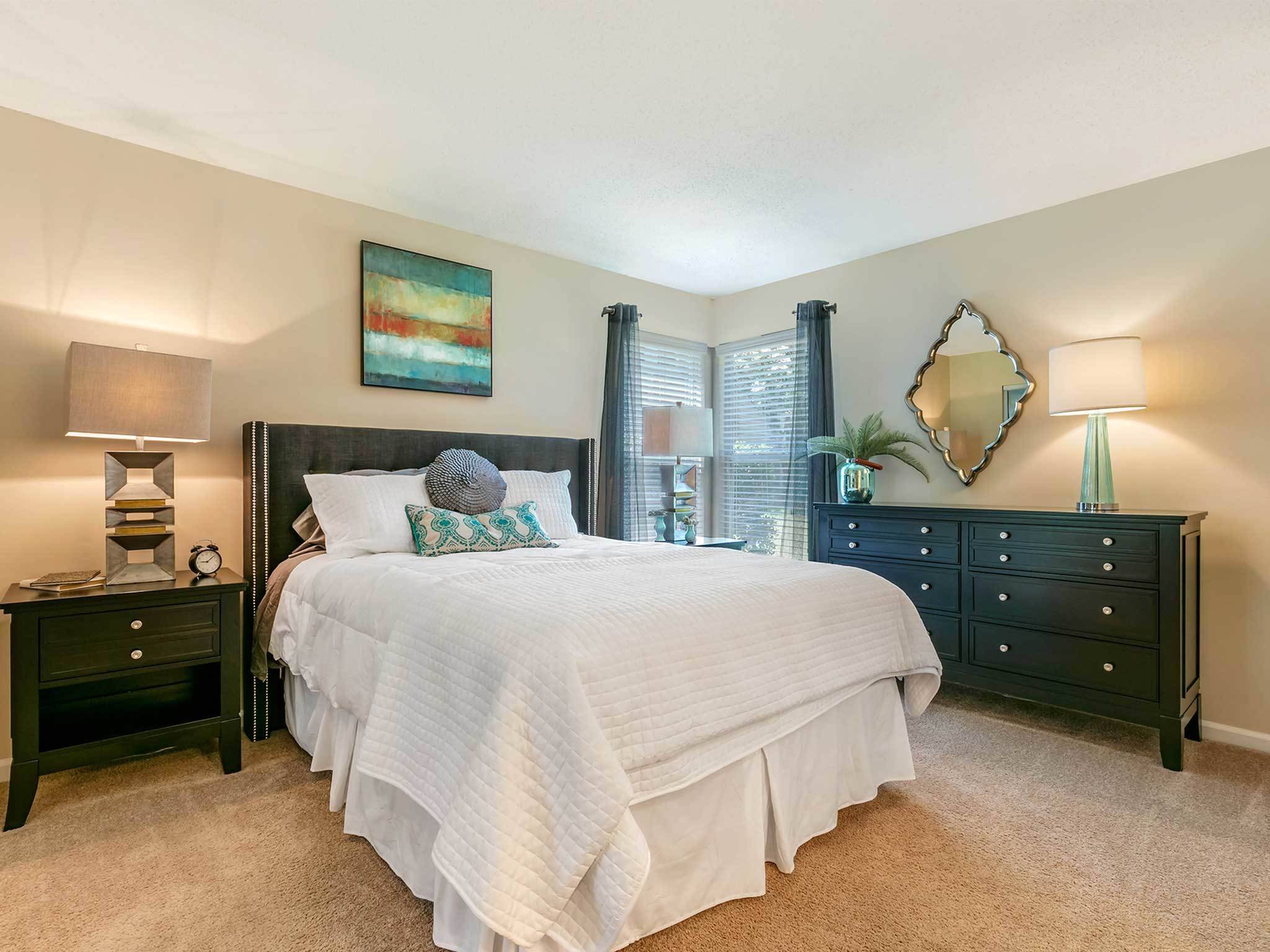 Large bedroom with corner windows, cozy carpeting