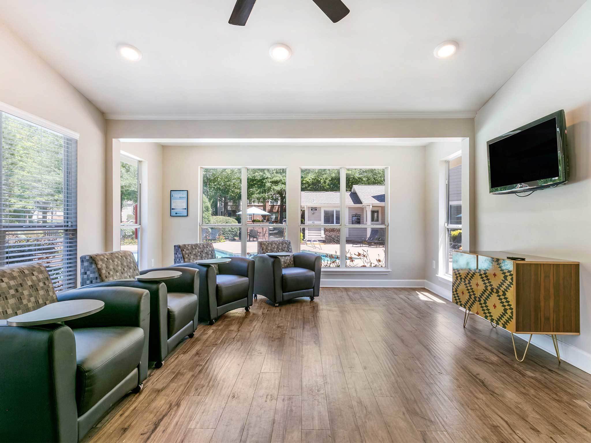 Community entertainment room with lounge chairs, and TV