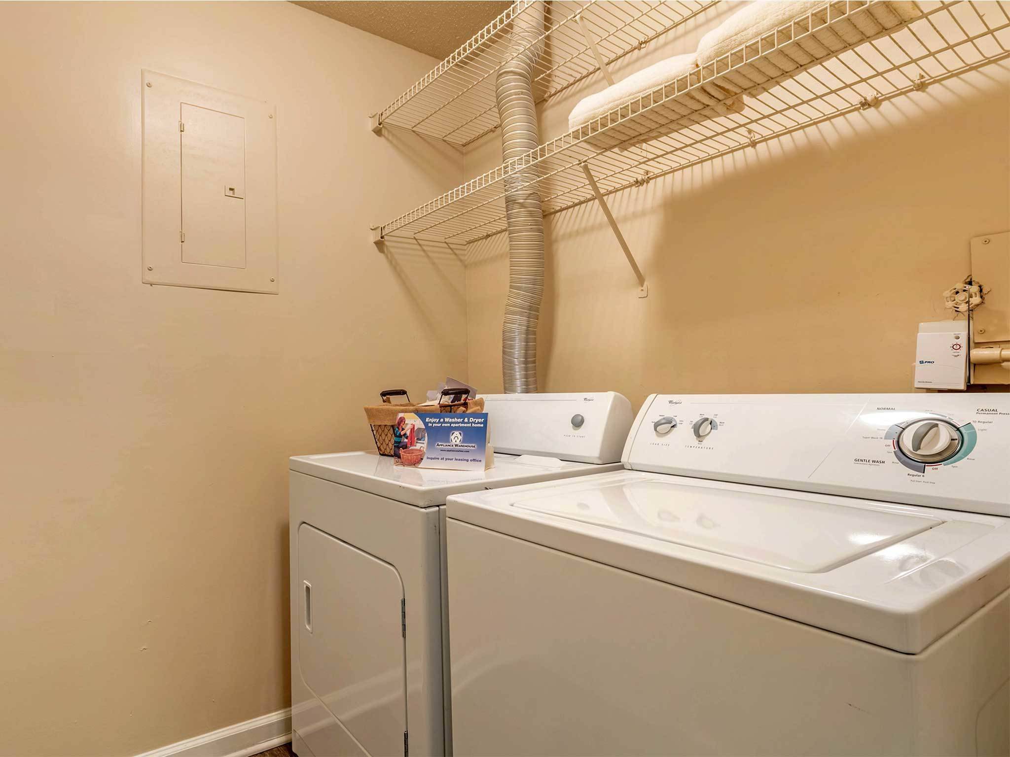 Spacious laundry room, with full-size washer and dryer. Two racks of over-laundry storage
