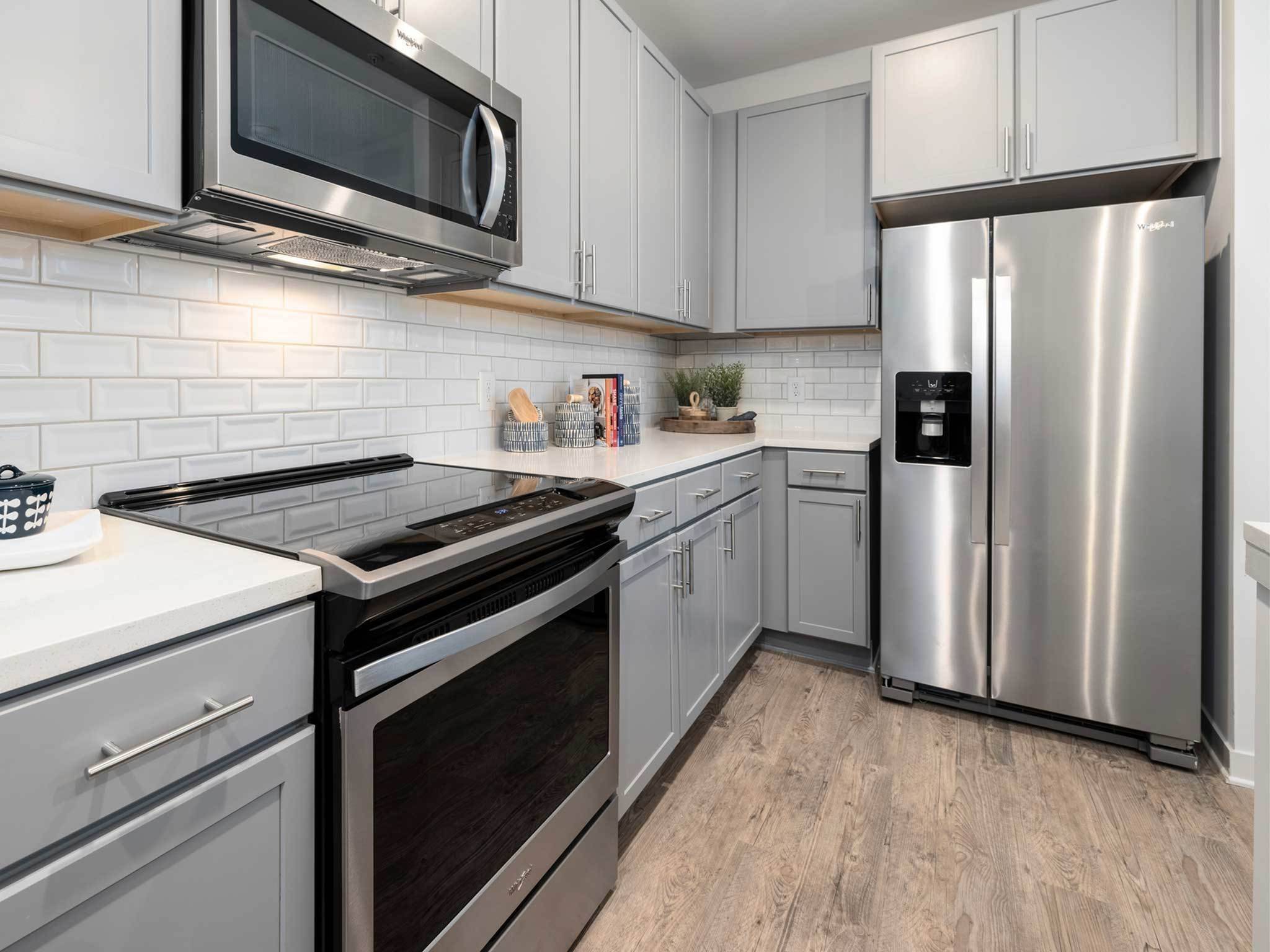 Gourmet kitchen, stainless steel appliances, electric stovetop, quartz countertops