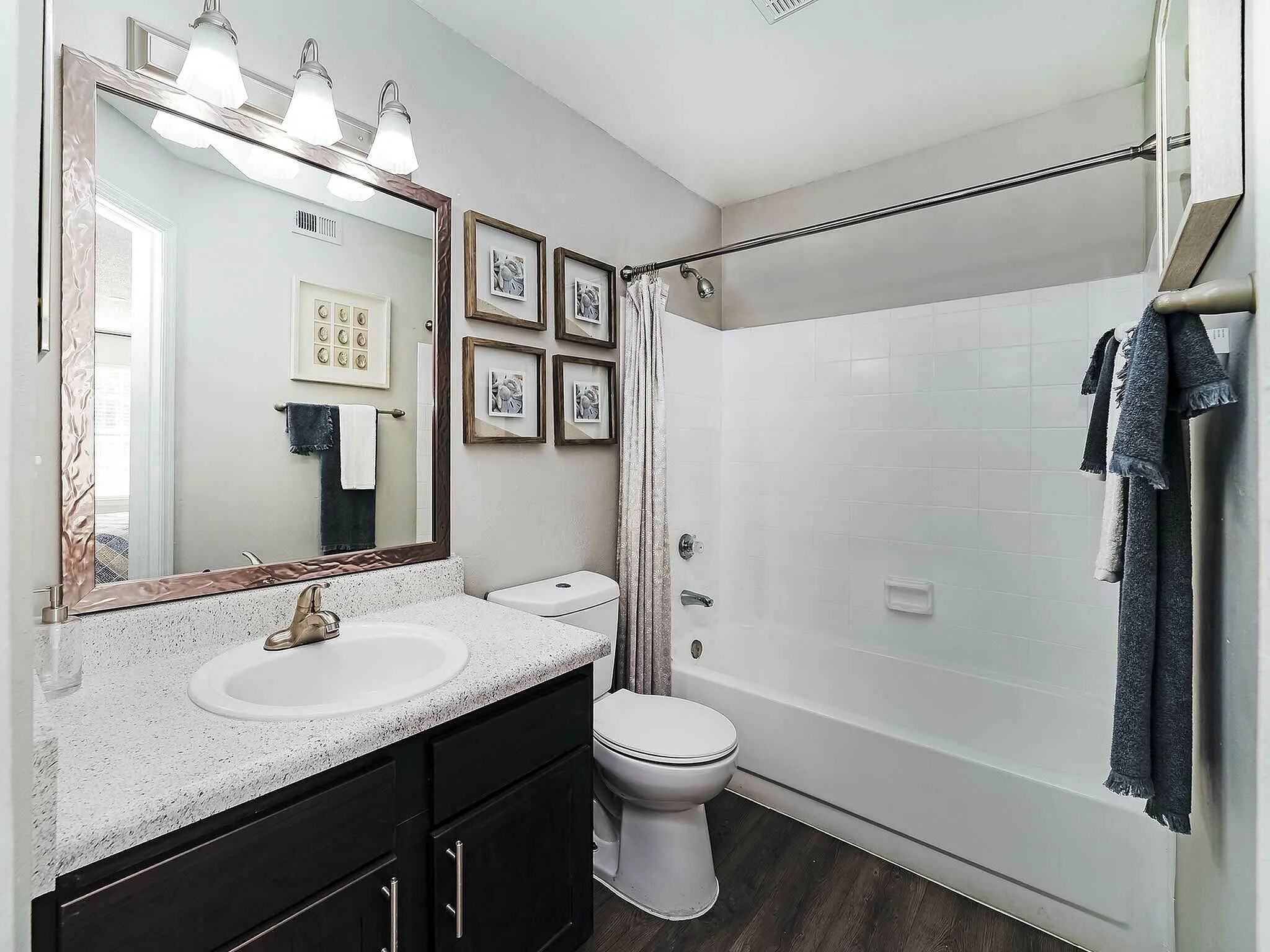 Luxurious bathroom with modern fixtures, a large mirror, and a relaxing bathtub.