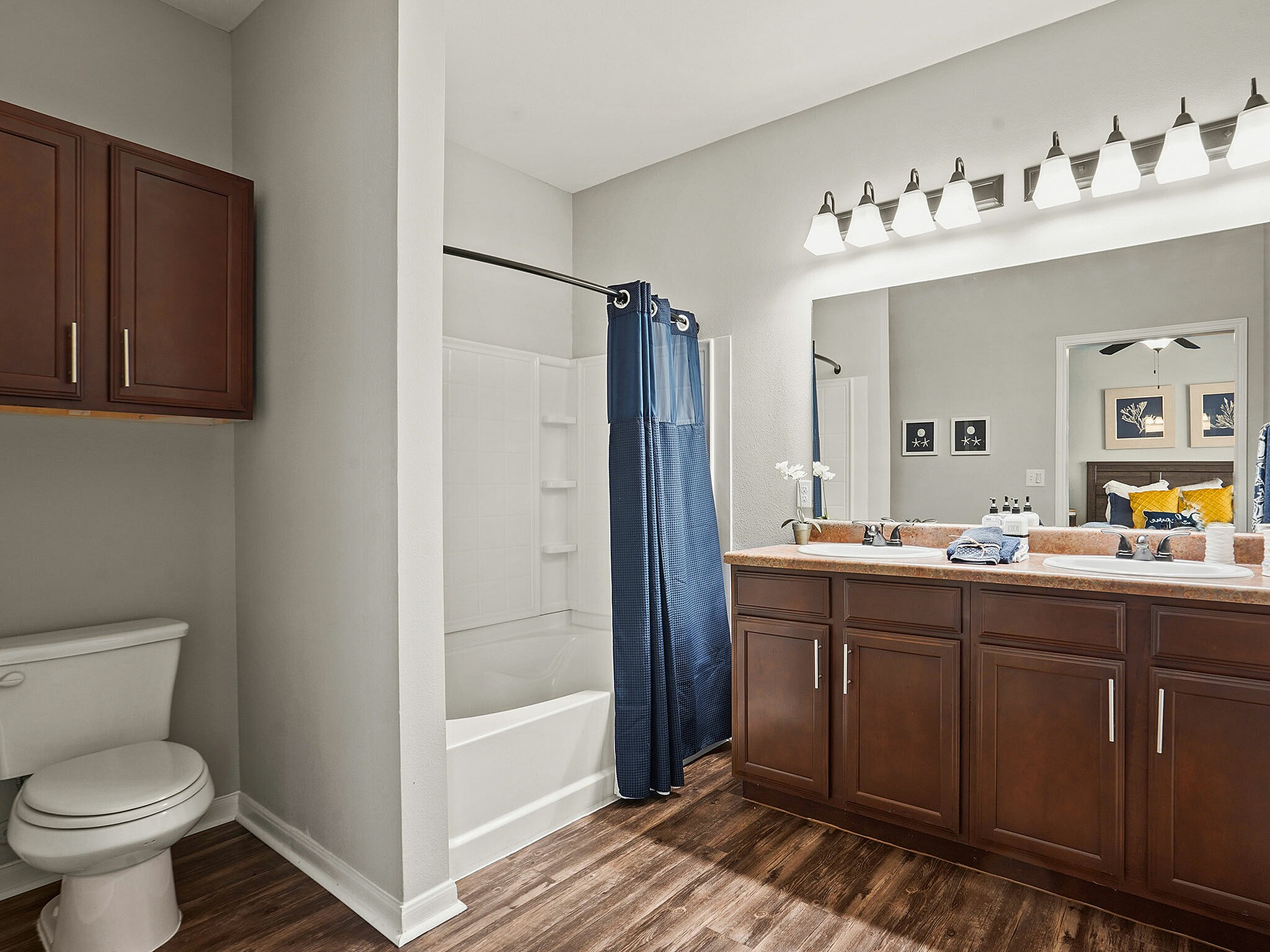 Inviting bathroom with dual sinks, modern cabinetry, and a sleek shower curtain.
