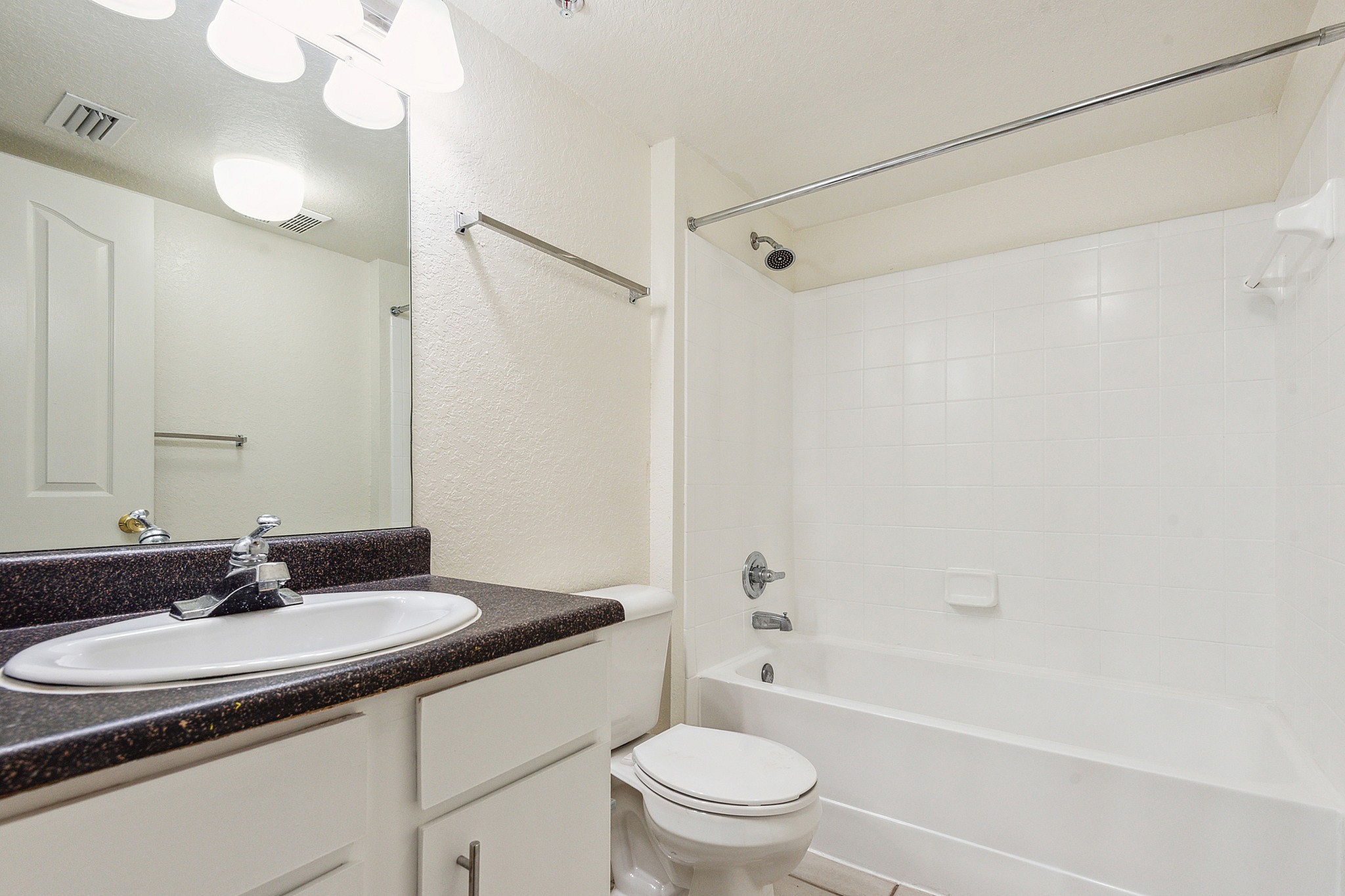 Elegant bathroom with a spacious white bathtub, modern fixtures, and a sleek countertop sink.