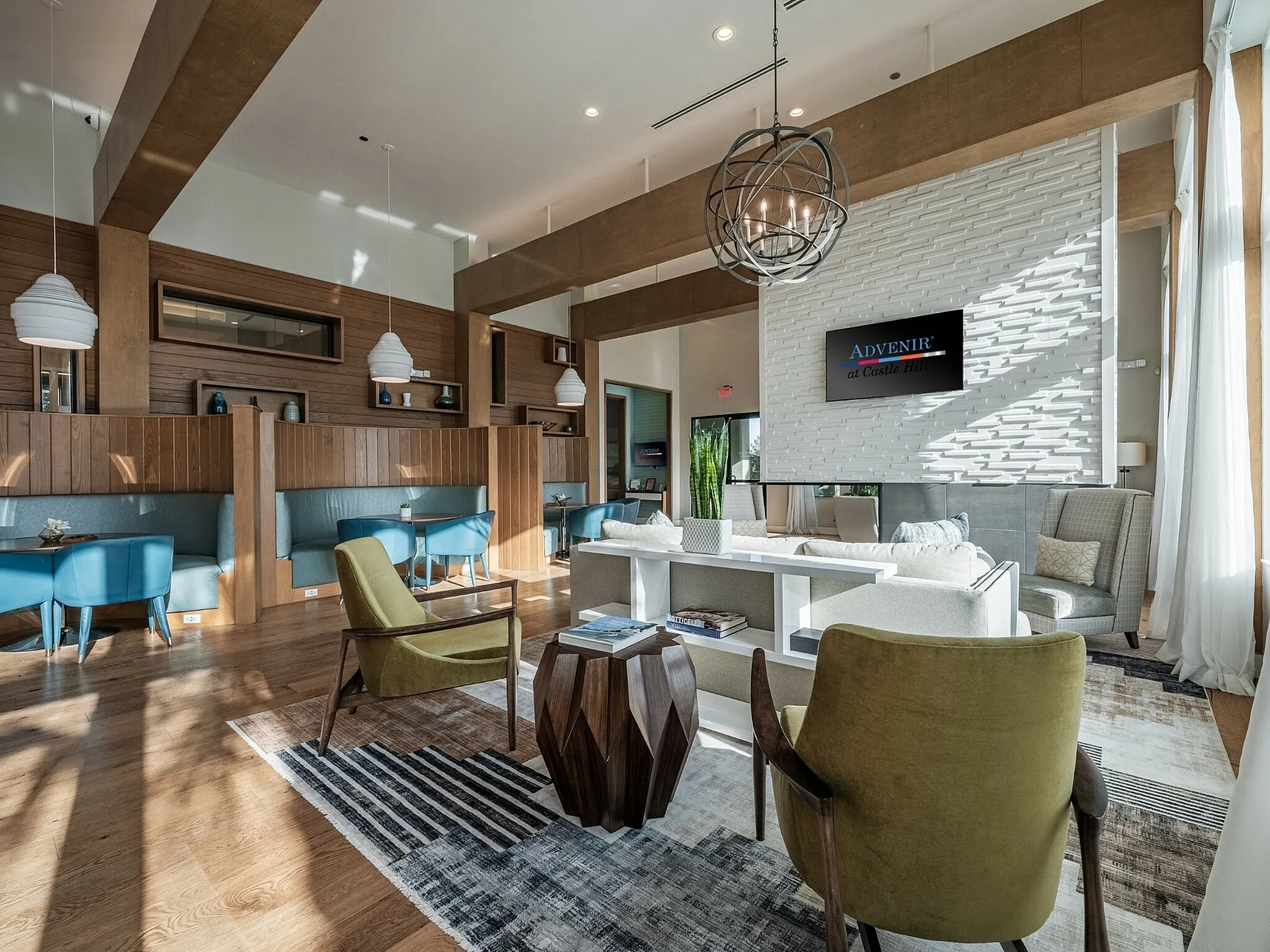 Elegant and modern lounge area with stylish seating, natural lighting, and chic decor at a luxury apartment complex.