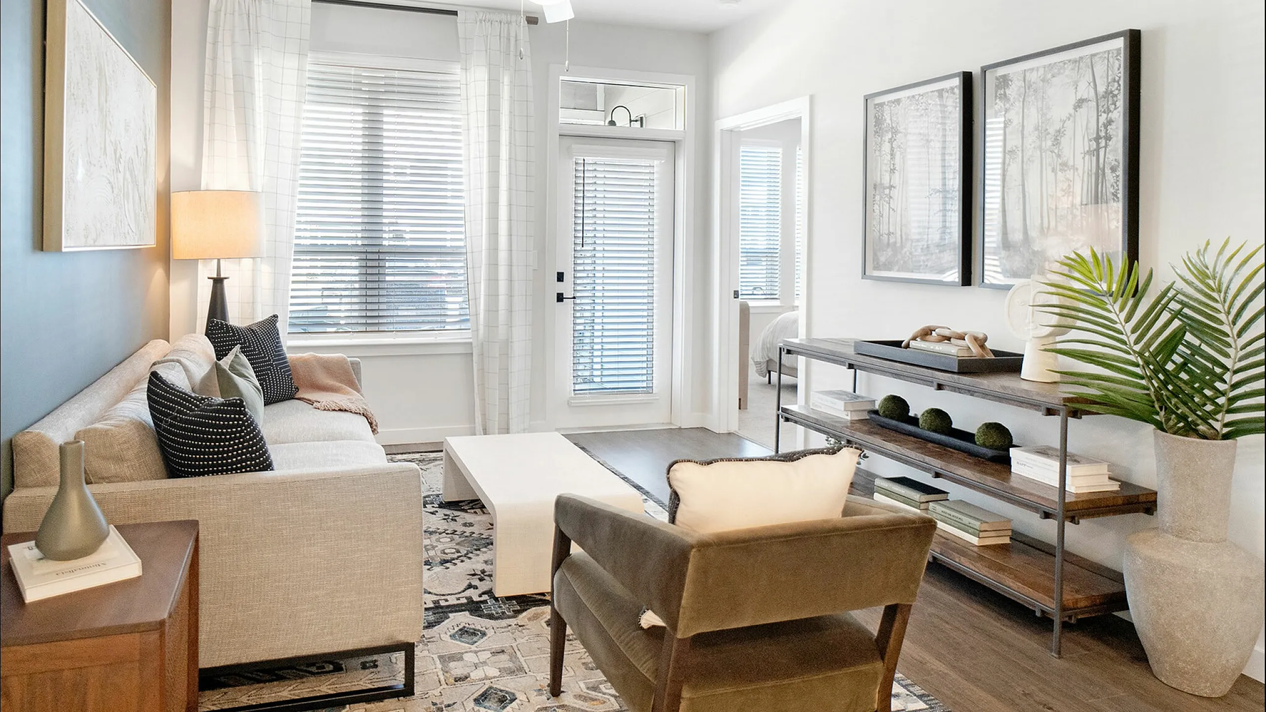 Elegant and cozy living room with stylish furniture, large windows, and tasteful decor.