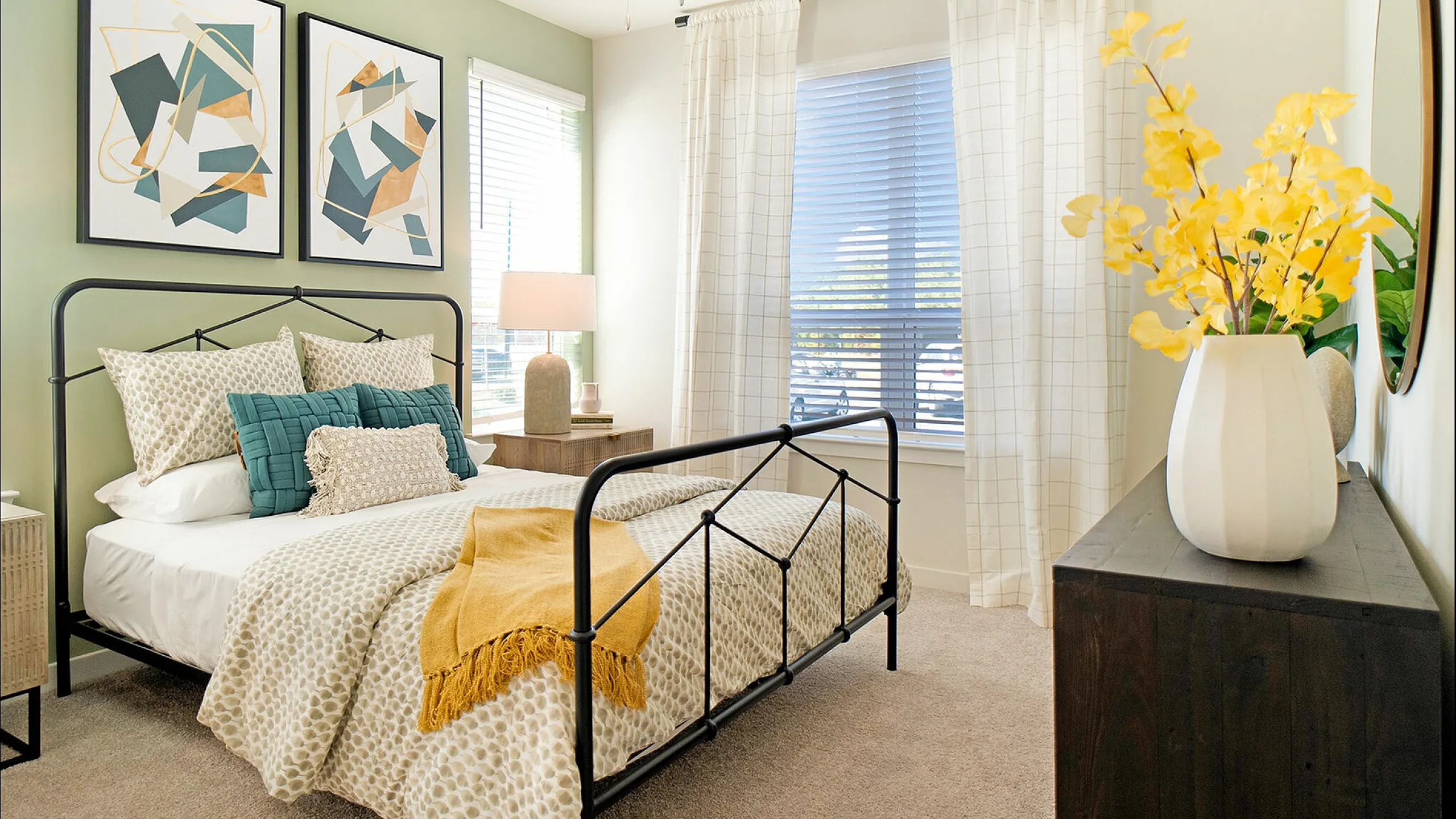 Chic bedroom with stylish decor, abstract art, and natural lighting
