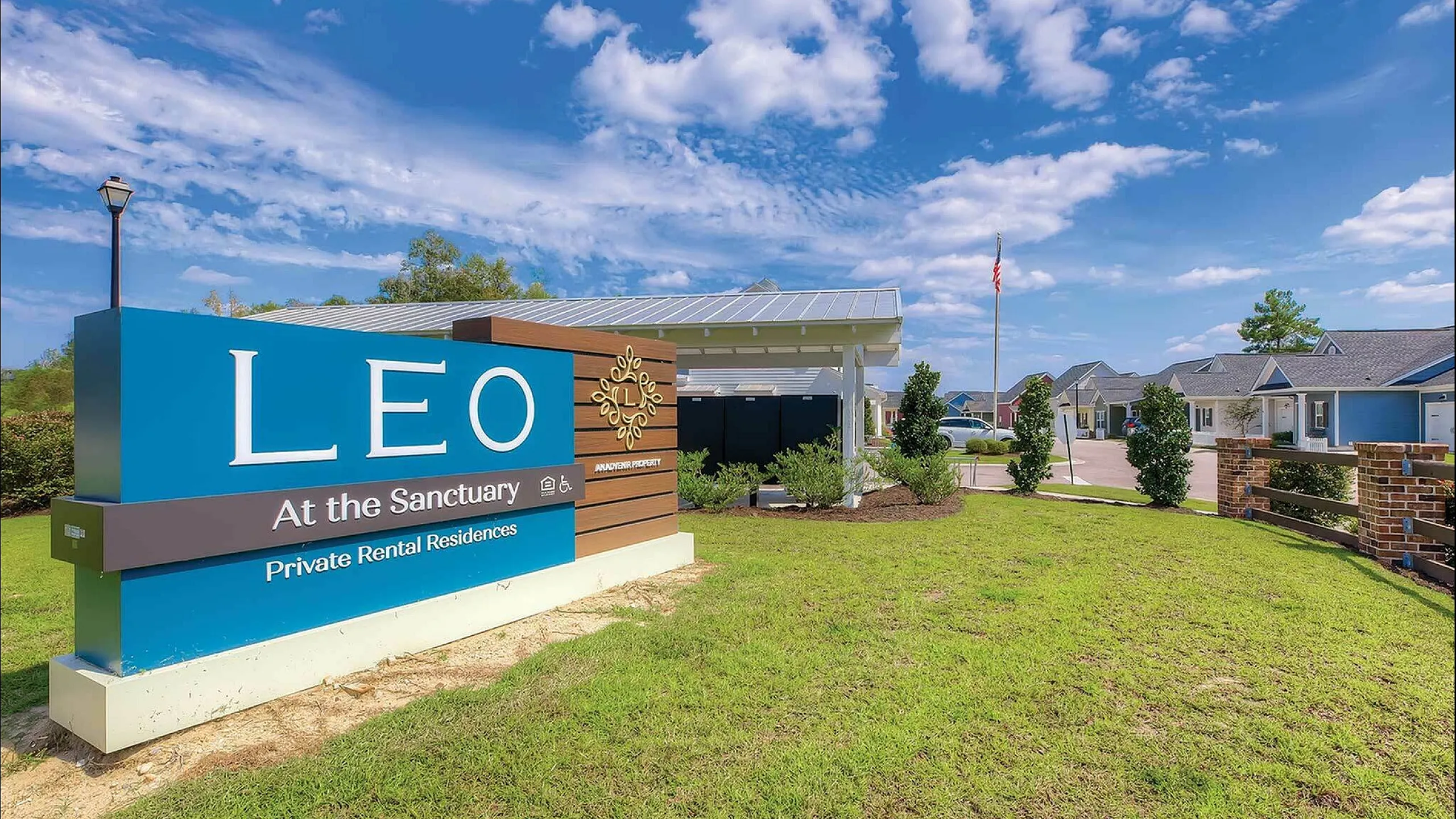 Entrance sign for LEO at the Sanctuary Private Rental Residences under a vibrant blue sky.