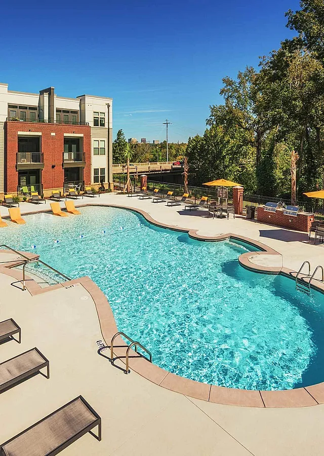 Contemporary apartment complex with a beautiful outdoor swimming pool and lounging area