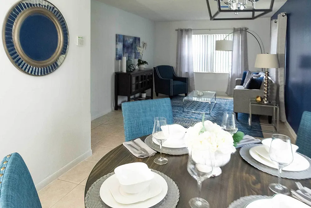 Stylish dining table set with chic living room in modern apartment.