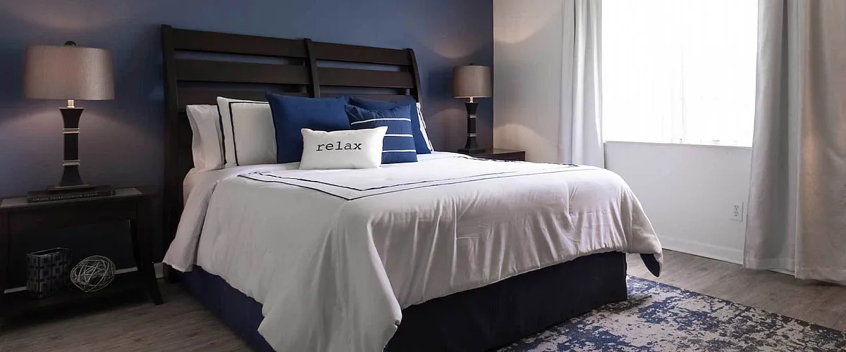 Cozy bedroom with elegant decor, featuring a comfortable bed, stylish nightstands, and soft lighting.
