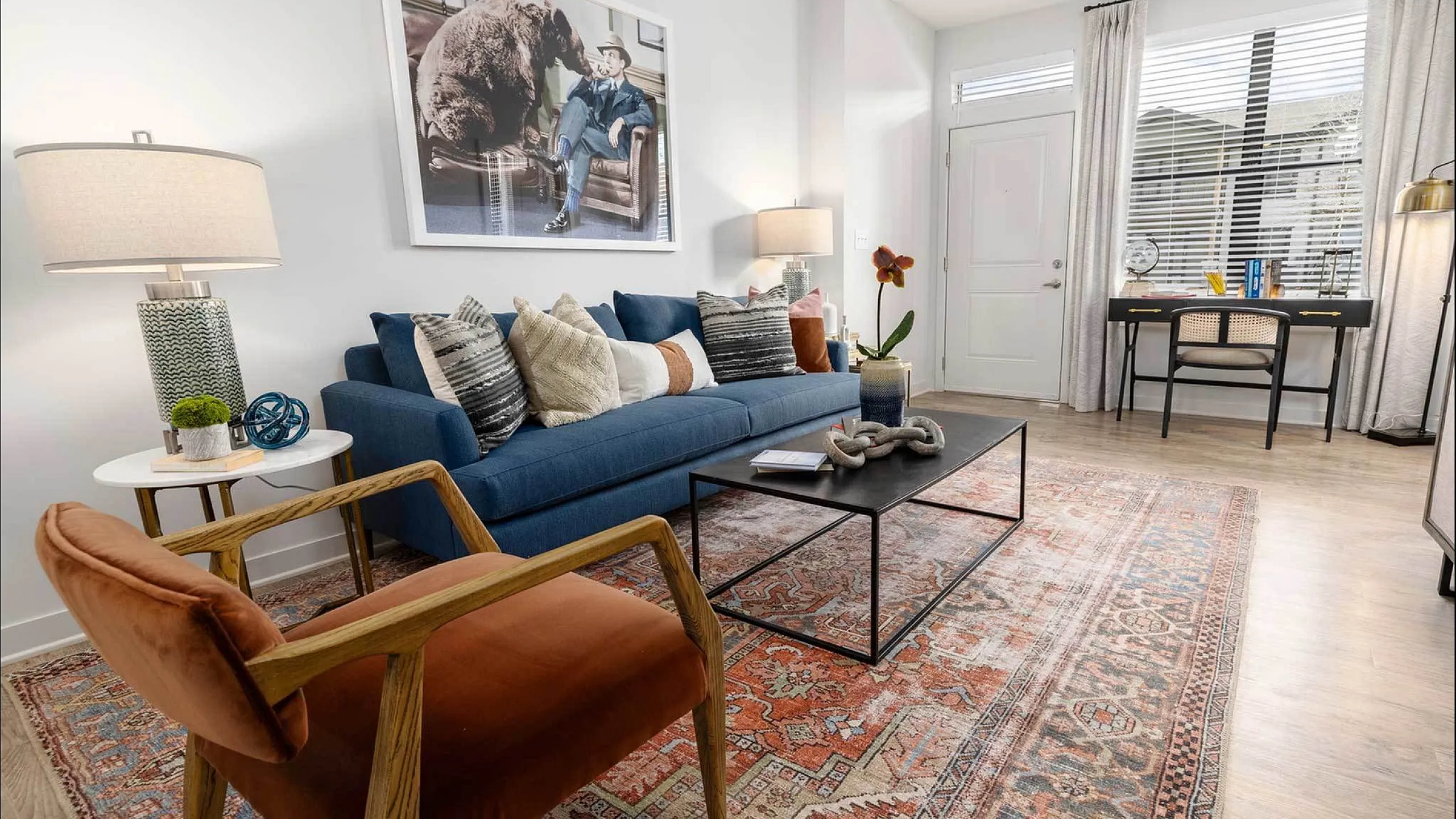 Chic and inviting living room with stylish furniture, vibrant art, and natural light