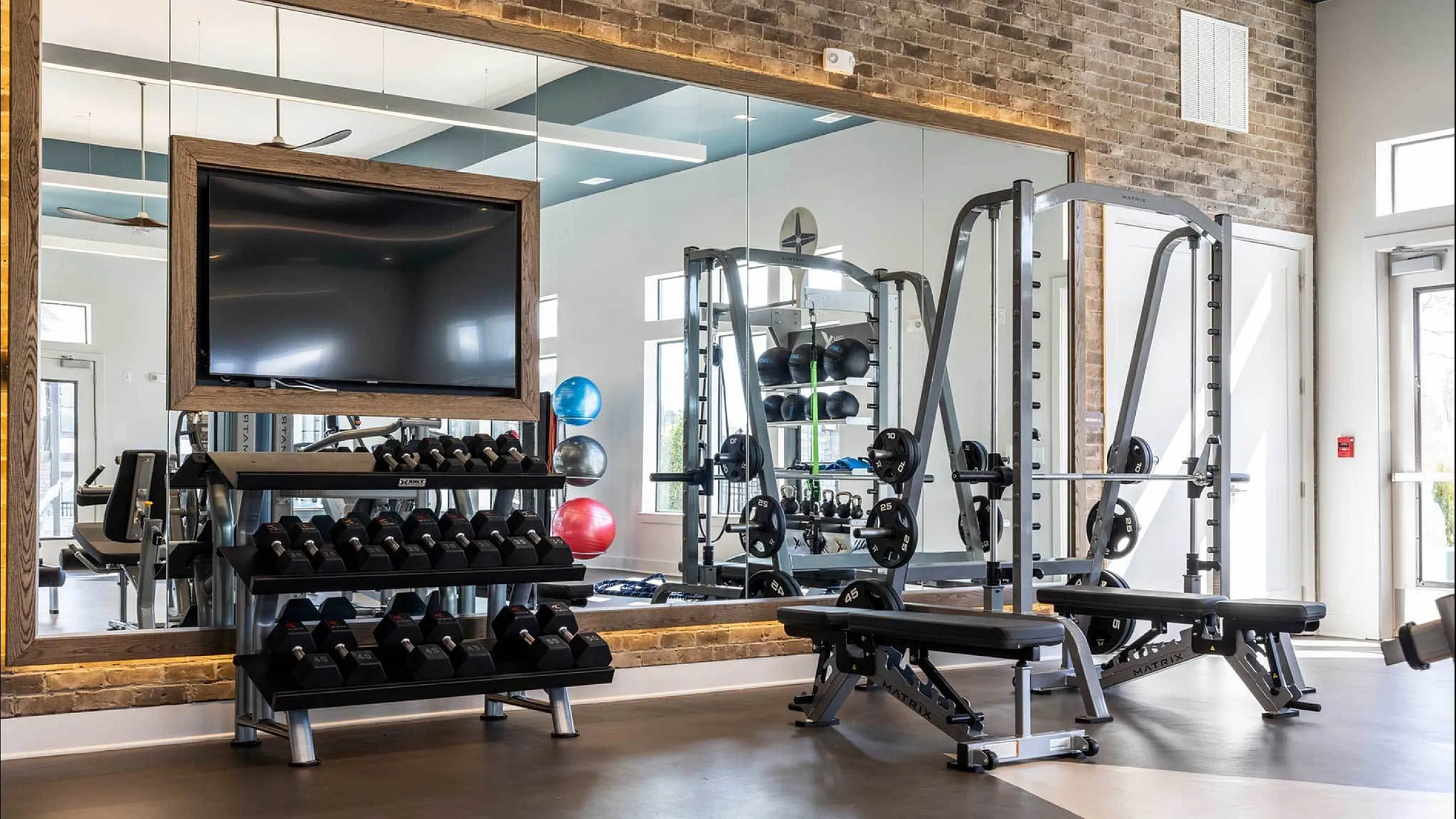 Contemporary fitness center with state-of-the-art equipment and weights.