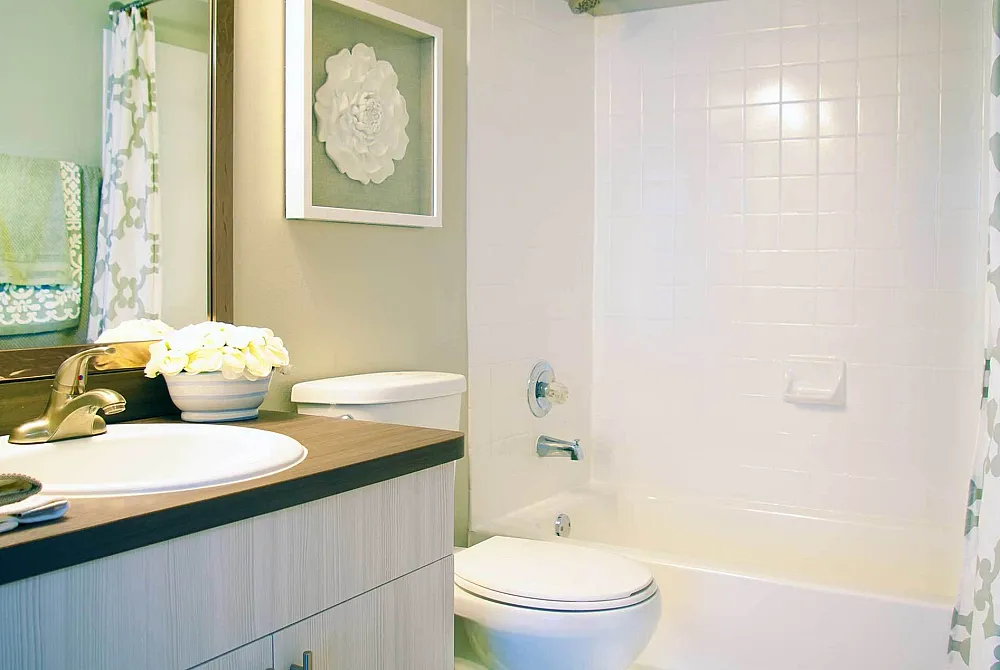Modern bathroom with stylish fixtures and floral decor